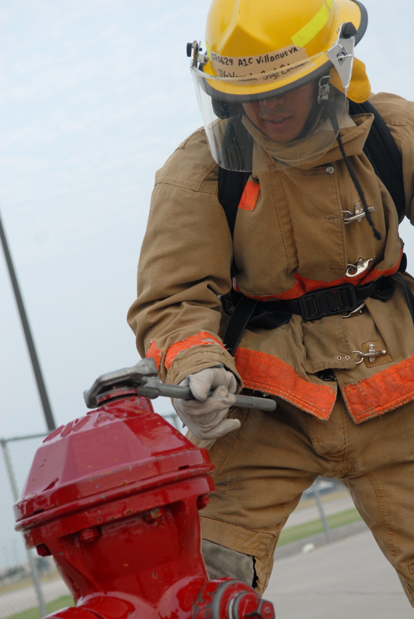 Airman 1st Class Oliver Villanueva, a student from the 312th Training Squadron, practices fire hydrant procedures Aug. 16. Students are taught the importance of using personal protective equipment, such as their gloves, to ensure safety at all times. (U.S. Air Force photo by Airman 1st Class Kamaile Chan)