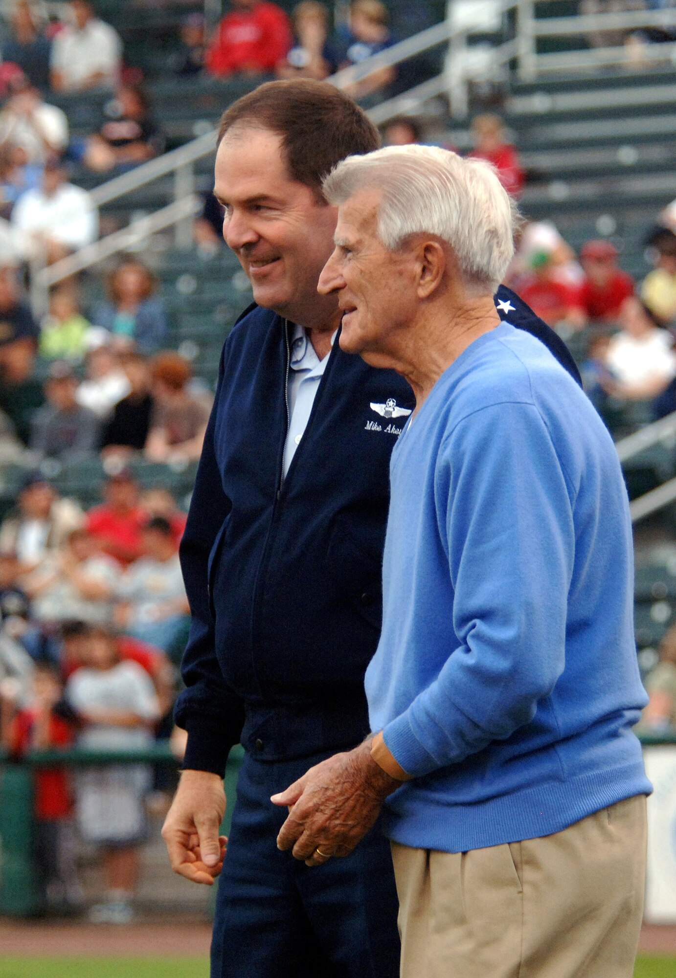 As part of Air Force Week New England festivities, Boston Red Sox icon Johnny Pesky, 87, gives Maj. Gen. Michael A. Akey, chief of staff of the Massachusetts Air National Guard, some advice before throwing out the first pitch for the Lowell, Mass., Spinners, a minor league team of the Boston Red Sox.  (U.S. Air Force photo/Staff Sgt. Bennie J. Davis III)
