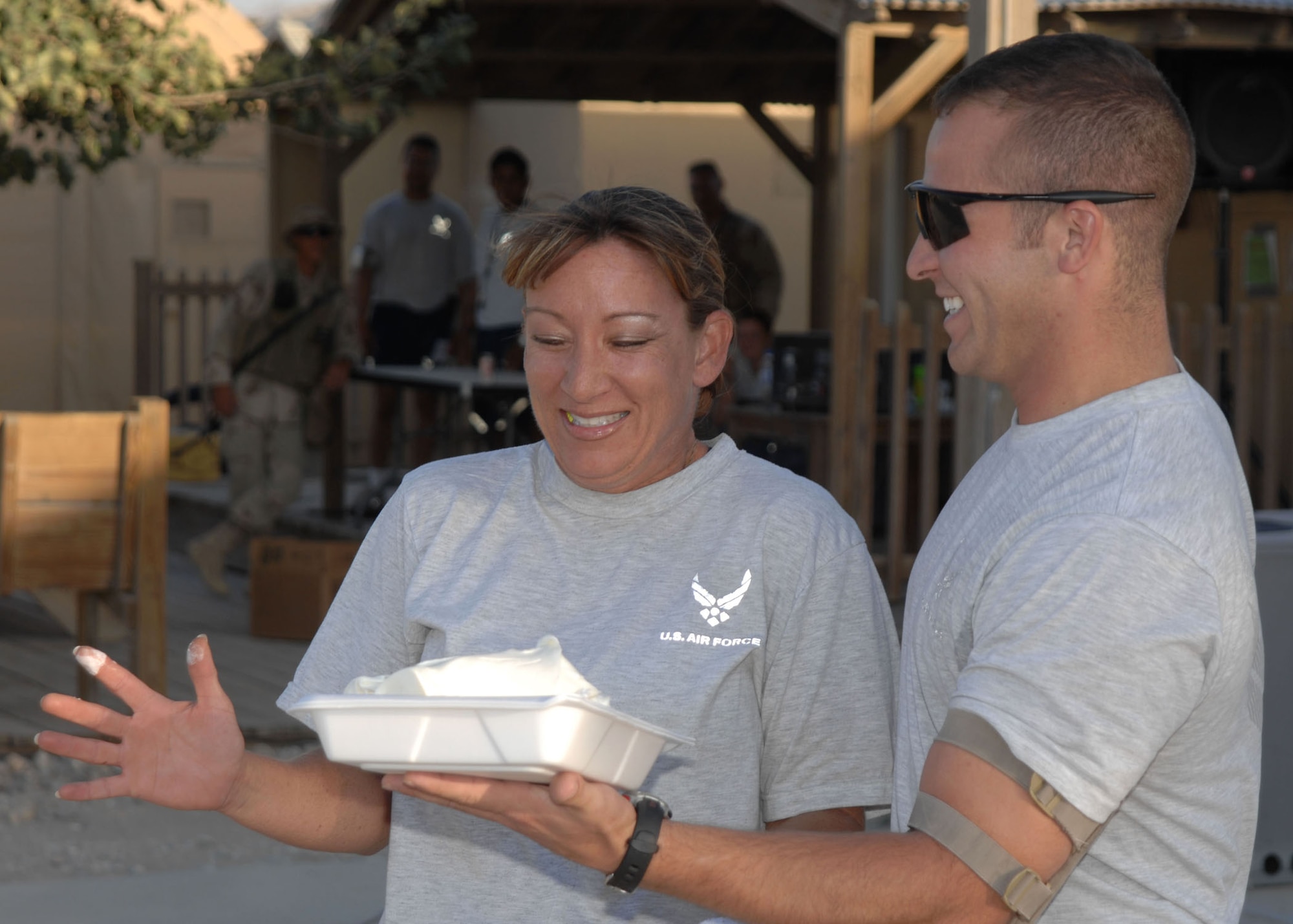 Master Sgt. Theresa Sheheen, 455th Expeditionary Aeromedical Evacuation Flight, prepares for her pie from Staff Sgt. Eric Emmett, 455th EAEF. Sergeant Sheheen received the highest bid of the evening, reaching 100 dollars. (U.S. Air Force photo by Senior Master Sgt. Kim Allain)