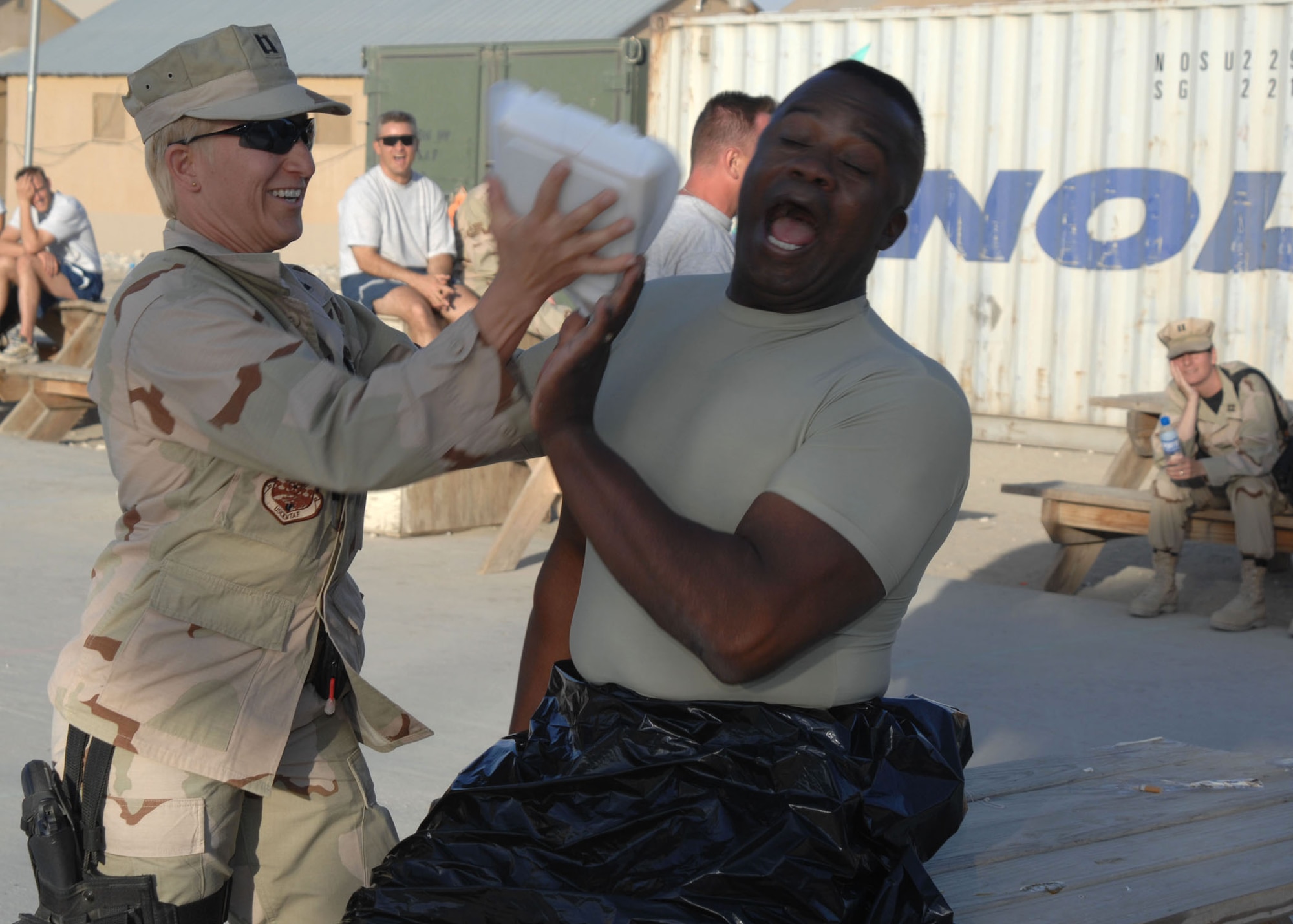 Capt. Christina Stone, 455th Air Expeditionary Wing protocol, plants a pie in the face of Chief Master Sgt. Ezell Buxton, 455th Expeditionary Maintenance Group chief enlisted manager. (U.S. Air Force photo by Senior Master Sgt. Kim Allain)