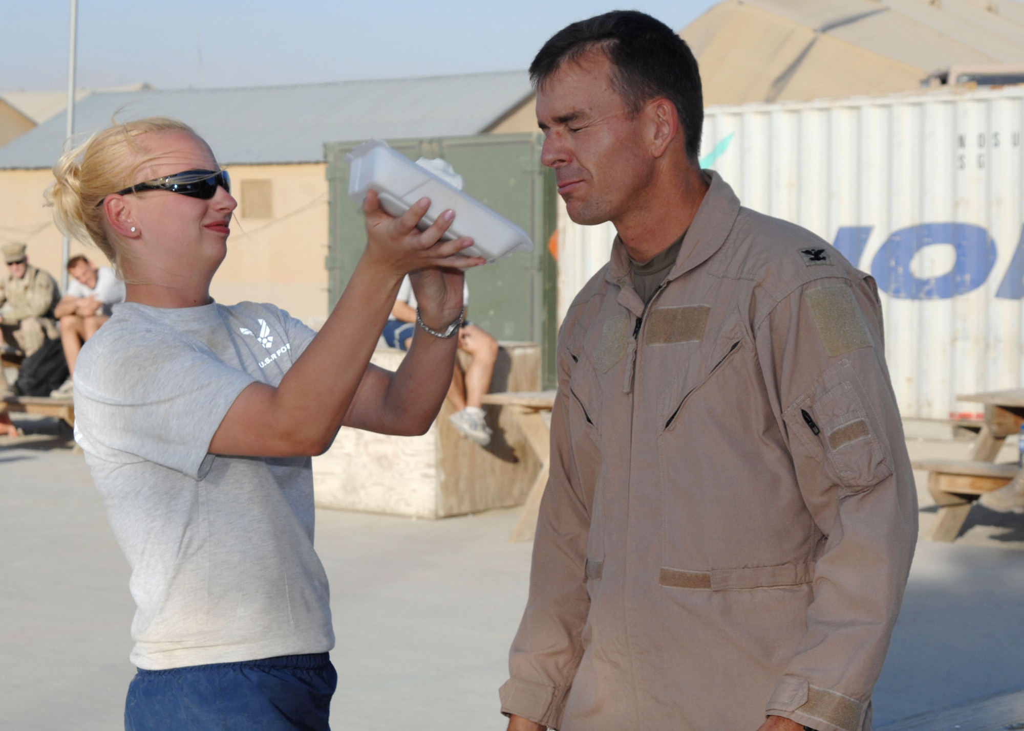 Col. Bruce McClintock, 455th Air Expeditionary Wing vice commander, gets a pie in the face from his highest bidder. Col. McClintock's bid went for 65 dollars for the chance to put a pie in his face. (U.S. Air Force photo by Senior Master Sgt. Kim Allain)