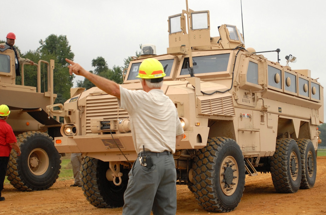 A test operator from Aberdeen Test Center, directs a mine-resistant, ambush-protected vehicle carrying media representatives during an orientation held by the Army Test and Evaluation Command on Aberdeen Proving Ground, Md., August 24, 2007.