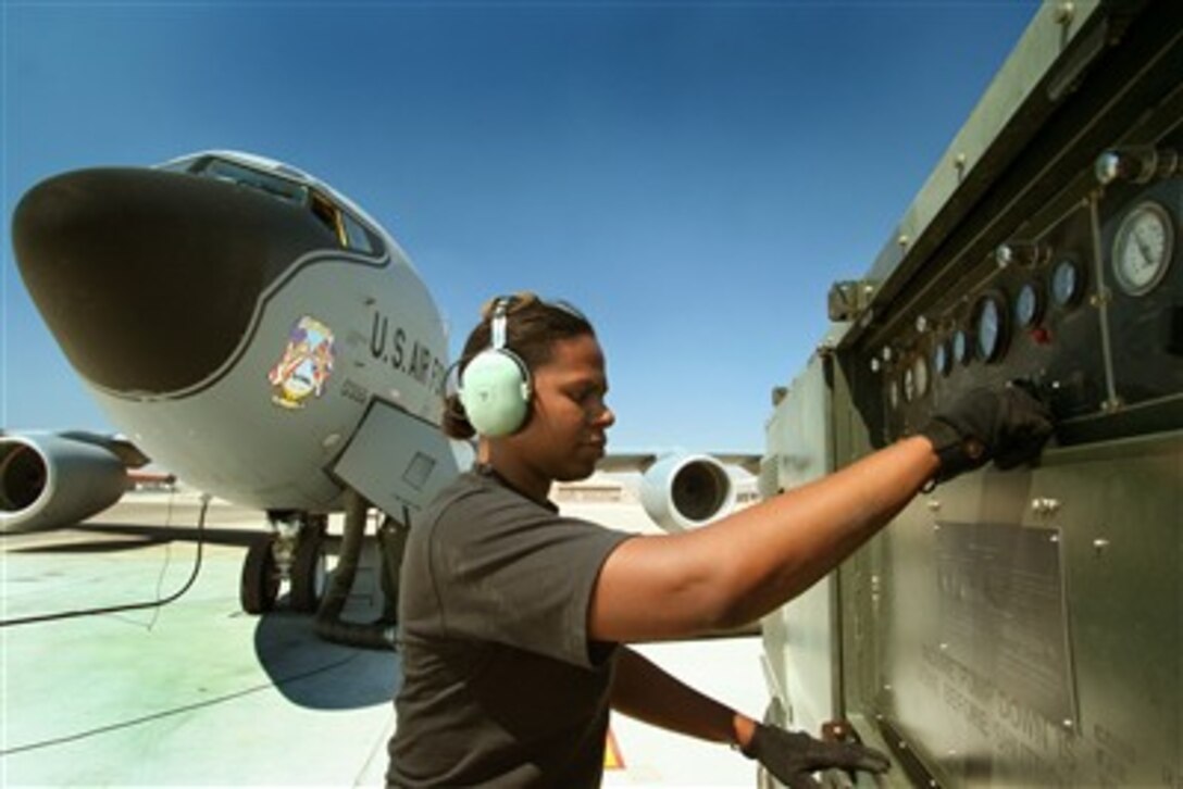 U.S. Air Force Staff Sgt. Stephanie Smith adjusts the controls on a portable air conditioning unit used to cool the interior of KC-135 Stratotanker aircraft in the extreme desert heat of Nellis Air Force Base, Nev., during exercise Red Flag 07-3 on Aug. 21, 2007.  Smith is a communications and navigations specialist with the 100th Air Refueling Wing out of Royal Air Force Mildenhall, England.  