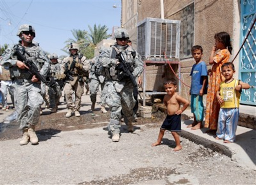 American troops and Iraqi security forces conduct a patrol in Ramadi, Iraq, Aug. 22, 2007.