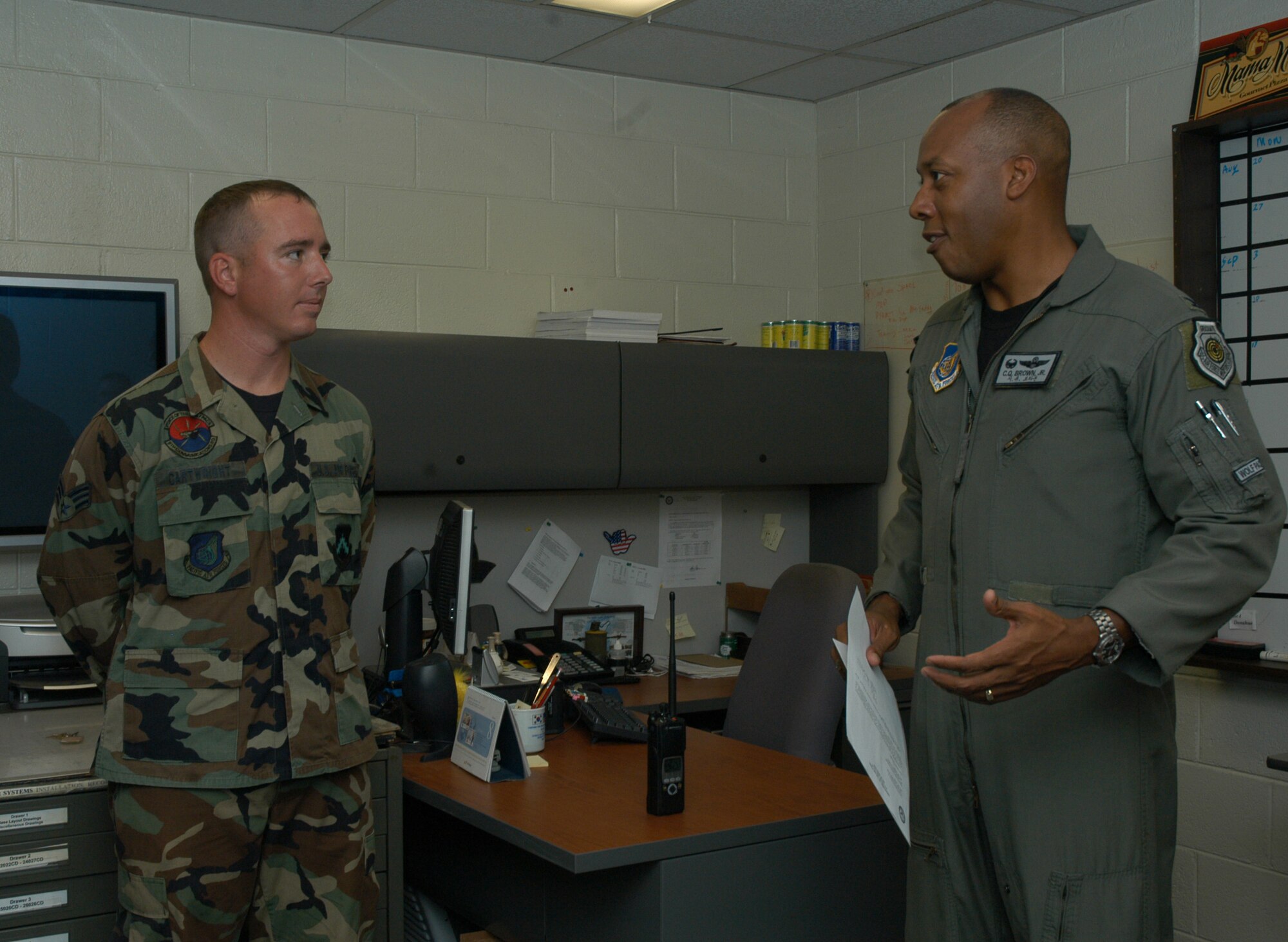 KUNSAN AIR BASE, South Korea -- Colonel CQ "Wolf" Brown, 8th Fighter Wing commander, talks to Senior Airman Joshua Cartwright, 8th Communications Squadron cable maintenance technician here Aug. 21. Airman Cartwright was recognized as the 8th FW's Pride of the Pack for the week of Aug. 20. (U.S. Air Force photo/ Staff Sgt. Araceli Alarcon)                               
