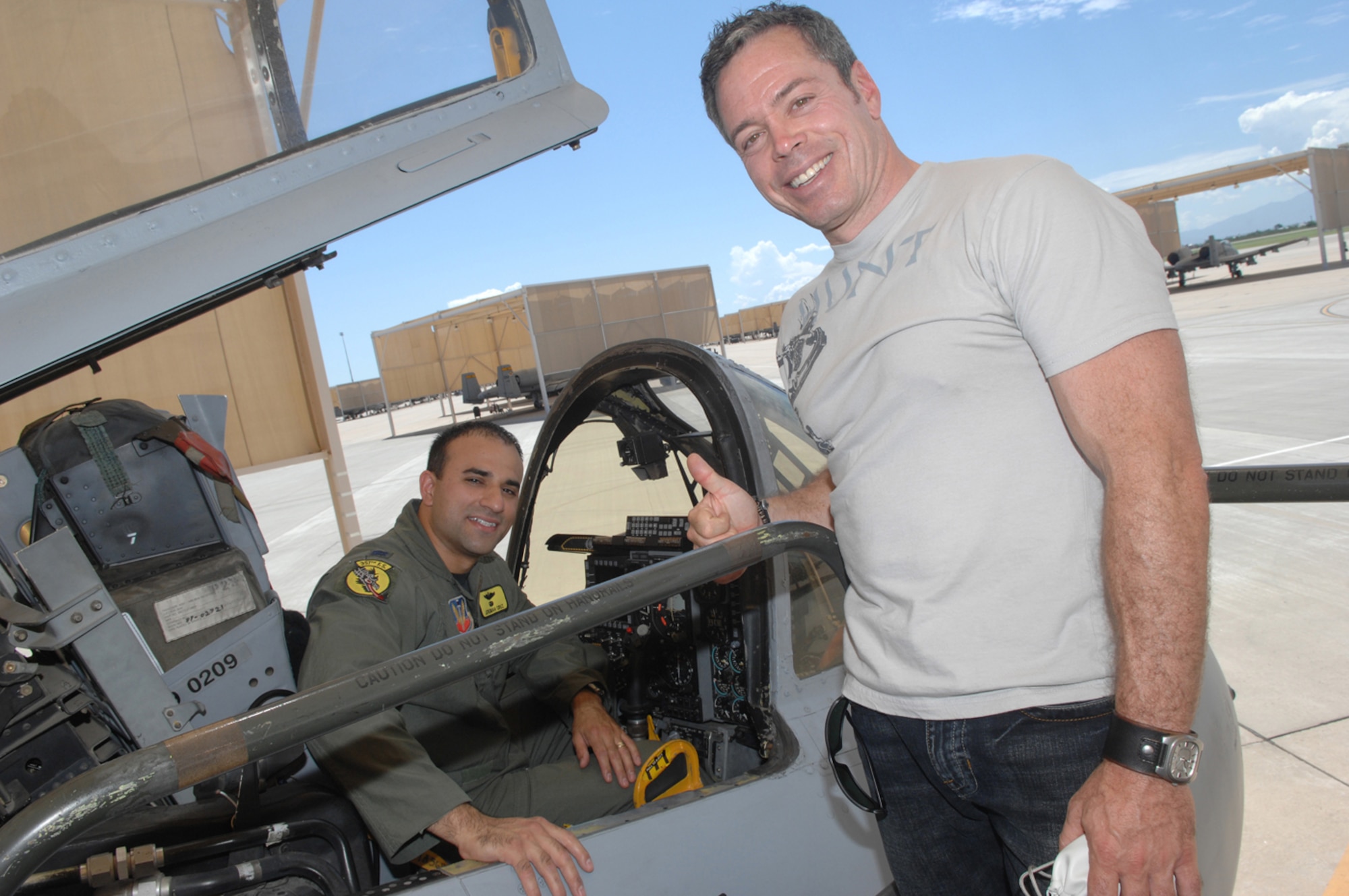 Comedian Bernie McGrenahan poses for a photo with Capt. Jeremiah Cruz, a 357th Fighter Squadron pilot, after touring the A-10C during his visit here Aug. 27. McGrenahan came to D-M as part of his national "Happy Hour" tour, and his hour-long performance featured both stand-up comedy and an inspirational message about alcohol awareness. His visit was sponsored by the base Culture of Responsible Choices Committee in their effort to promote responsible decision-making in young Airmen. (U.S. Air Force photo/Airman 1st Class Alesia Goosic)