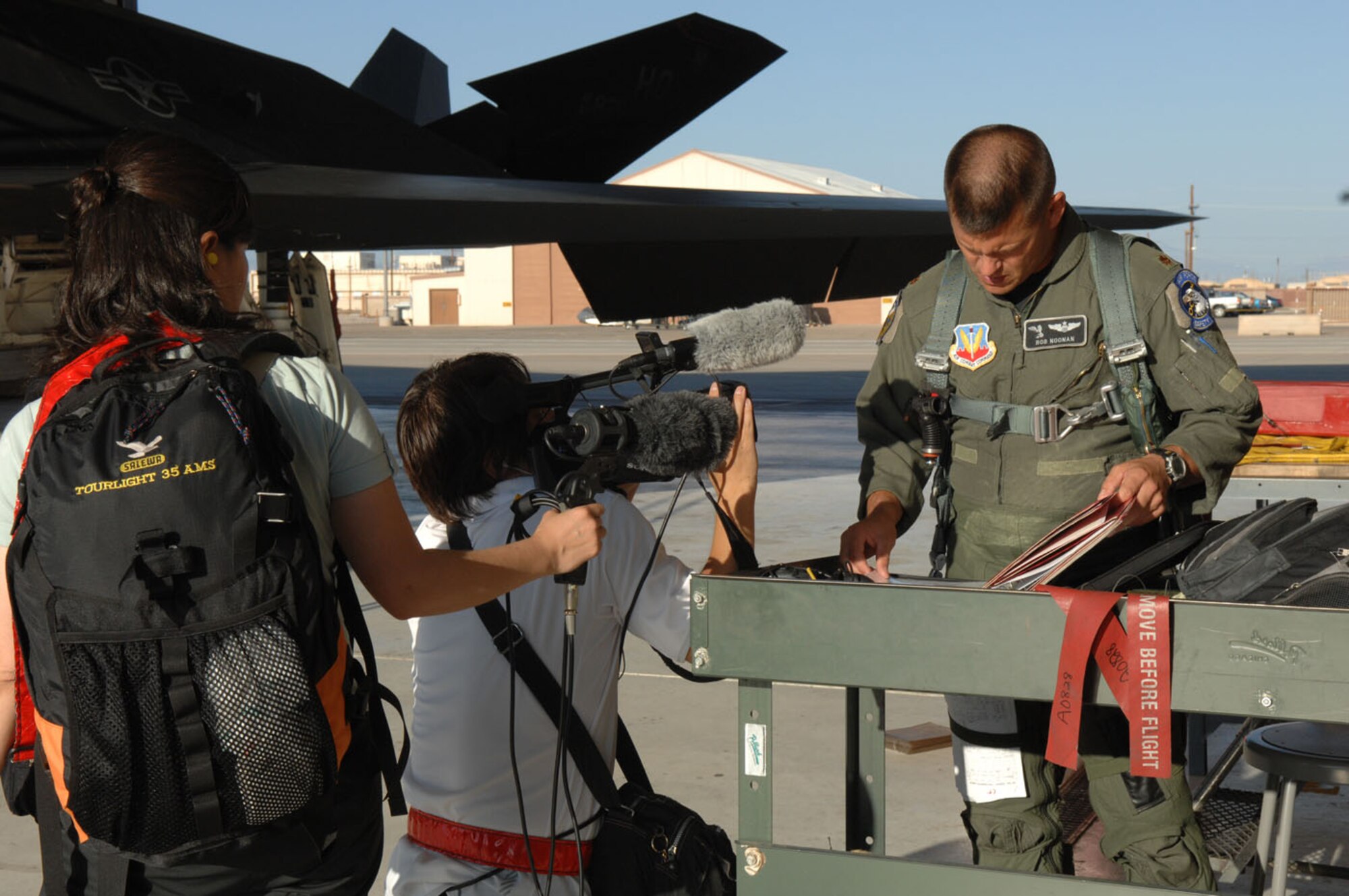 Cameraman and woman Chisato Okuma and Ryichi Takano from NTN television broadcasting station in Tokyo, Japan document Maj. Robert Nooman, 49th Fighter Wing chief of safety Aug. 27. Ryichi Takano and Chisato Okuma were at Holloman and Nellis Air Force Base documenting the history of the F-117 and its retirement. Also the crew follwed around Major Nooman for a day to capture the day in the life of a pilot in the U.S. Air Force. (U.S. Air Force photo/Senior Airman Anthony Nelson)
