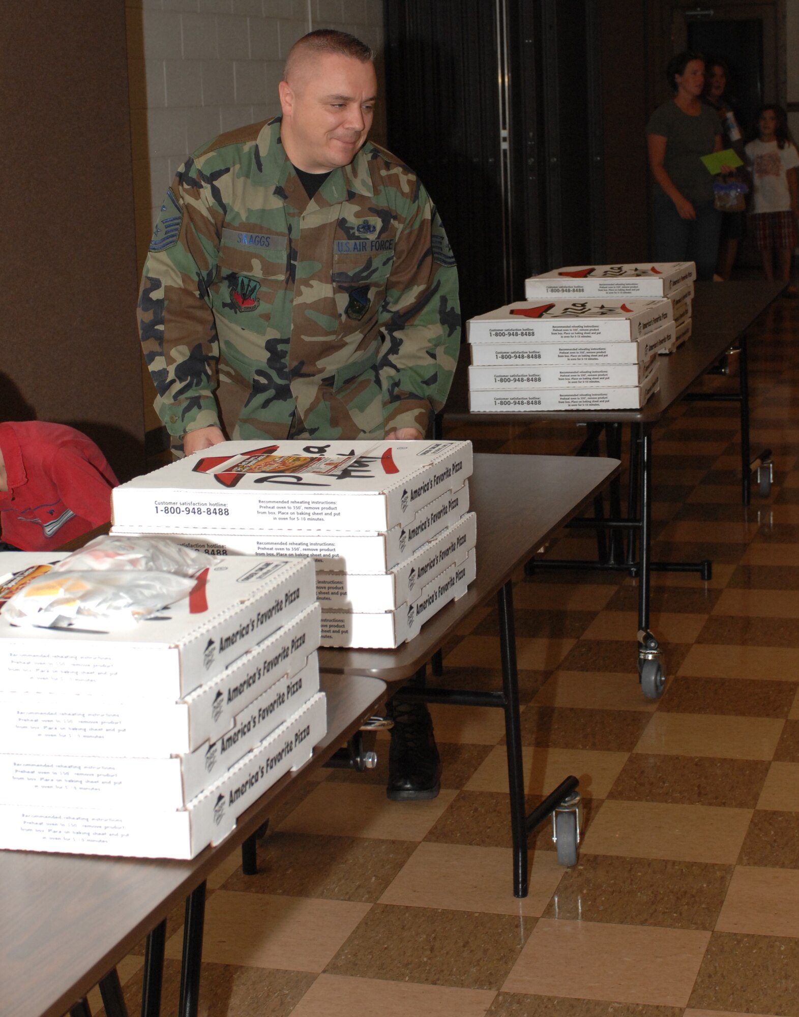 CANNON AIR FORCE BASE, N.M. -- Master Sgt. John Skaggs, 27th Aircraft Maintenance Squadron first sergeant, gets the pizzas ready during Operations Thanks Again, provided by Steve Rooney and Duffy Moon, local radio broadcasters from Clovis, N.M. The disc jockey duo recorded audio and video messages from family members of deployed Airmen that they brought with them to Anderson Air Force Base, Guam. (U.S. Air Force photo by Airman 1st Class Evelyn Chavez)