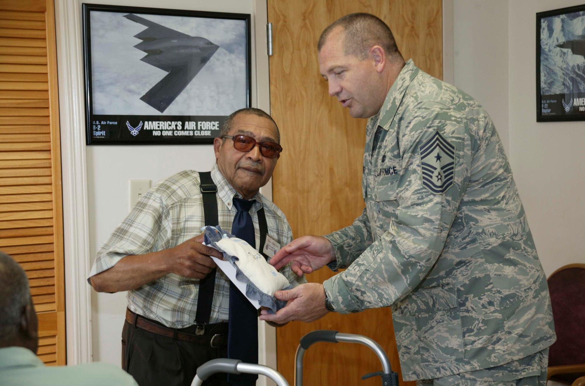 SUMTER, S.C. -- Chief Master Sgt. Scott Dearduff, 20th Fighter Wing command chief, receives a "care cushion" from George McCain, Hopewell Healthcare resident counsel president Aug. 24. The residents wanted to present a special memento to the Shaw Air Force Base Airmen for thier service to their country. (U.S. Air Force photo/Senior Airman Holly MacDonald)
