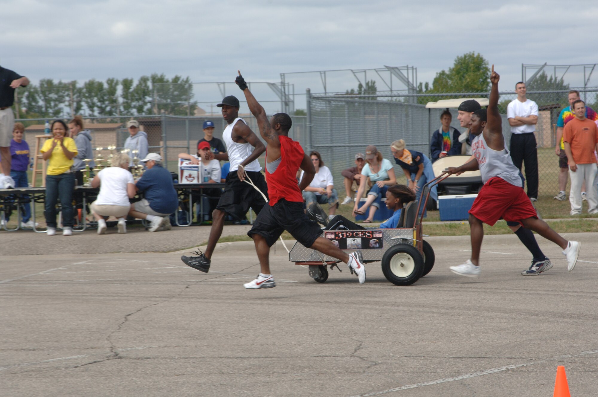 Members of the 319th Civil Engineers Squadron race to the finish line at the Bed Racing event during the Grand Forks Air Force Base Summer Bash on Aug. 23. The base personnel and family members participated in several sports including basketball, bowling and horse shoes.   (U.S. Air Force photo/Airman 1st Class Chad M. Kellum)