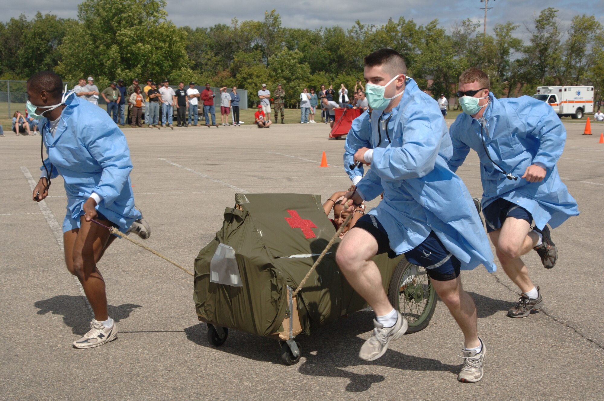 Airman First Class Clarissa Garza, 319th Mission Support and Services Squadron,  screams for her life as she and her teamates compete in the Bed Races during the Grand Forks Air Force Base Summer Bash on Aug. 23. The base personnel and family members participated in several sports including basketball, bowling and horse shoes.   (U.S. Air Force photo/Airman 1st Class Chad M. Kellum)