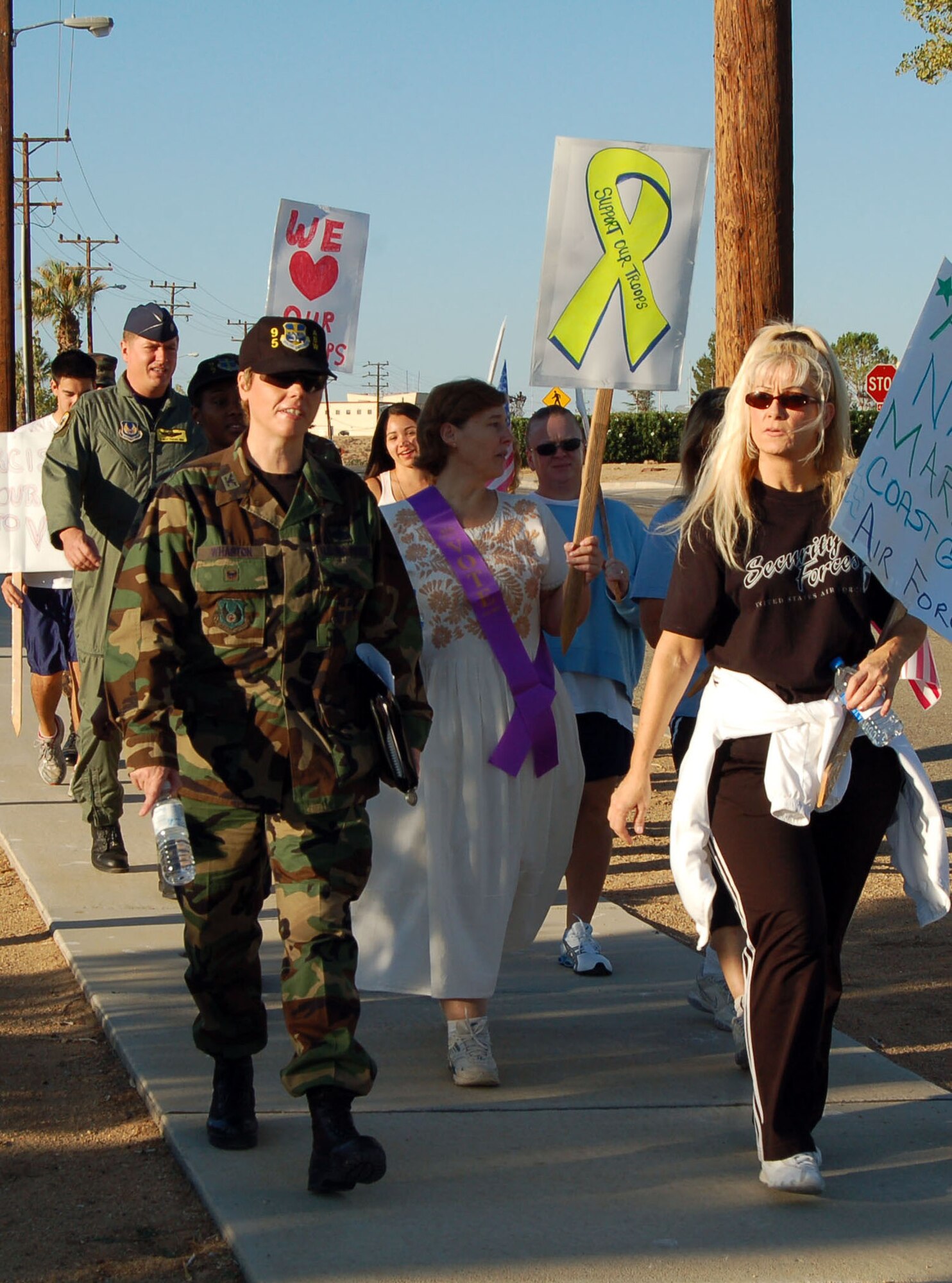 Team Edwards marches through Rosamond Boulevard during the Gratitude March from building 3000 to building 1 on Tuesday. The event was part of the Women's Equality Day week-long celebration sponsored by the Air Force Flight Test Center and NASA Dryden Flight Research Center. (Photo by Airman 1st Class Julius Delos Reyes)