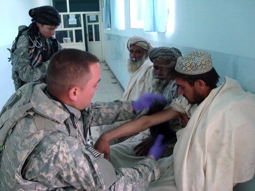 Staff Sgt. Eric Johnston wraps a blood pressure cuff around the arm of an Afghan patient during a Village Medical Outreach Aug. 22 in the Shinkay District, Afghanistan. Nearly 200 people were seen by Provincial Reconstruction Team Qalat medics. (U.S. Air Force photo/Capt. Bob Everdeen) 