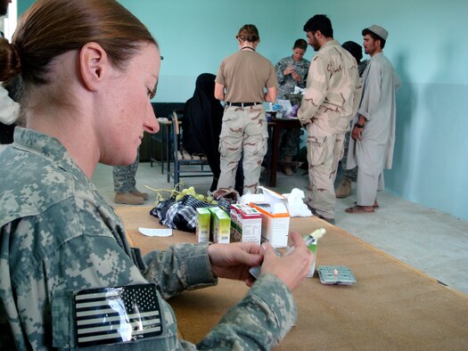 Staff Sgt. Jill Renshaw prepares de-worming medication for Afghan patients during a Village Medical Outreach Aug. 22 in the Shinkay District, Afghanistan. Nearly 200 people were seen by Provincial Reconstruction Team Qalat medics. (U.S. Air Force photo/Capt. Bob Everdeen) 