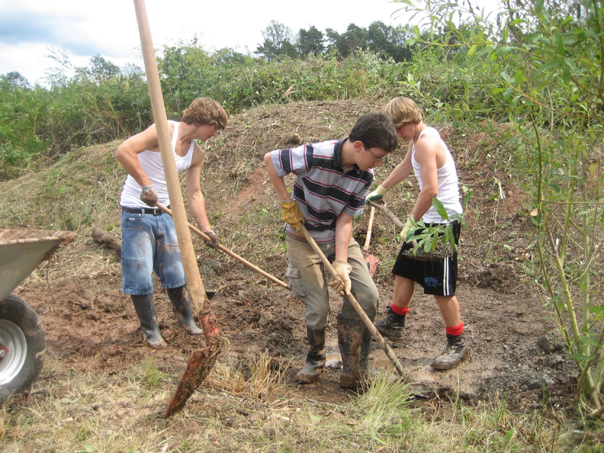 SPANGDAHLEM AIR BASE, Germany – From left: Daniel Demers, Anthony Ciranni and Dillon Demers, all Scouts from Spangdahlem’s Boy Scout Troop 165, work to reclaim a wetland on the air base Aug. 19 to house frogs, toads, salamanders and other wildlife. The service project is a final step for fellow Scout Jordan Thomas to earn the rank of Eagle Scout. (U.S. Air Force photo/Staff Sgt. Andrea Knudson)    