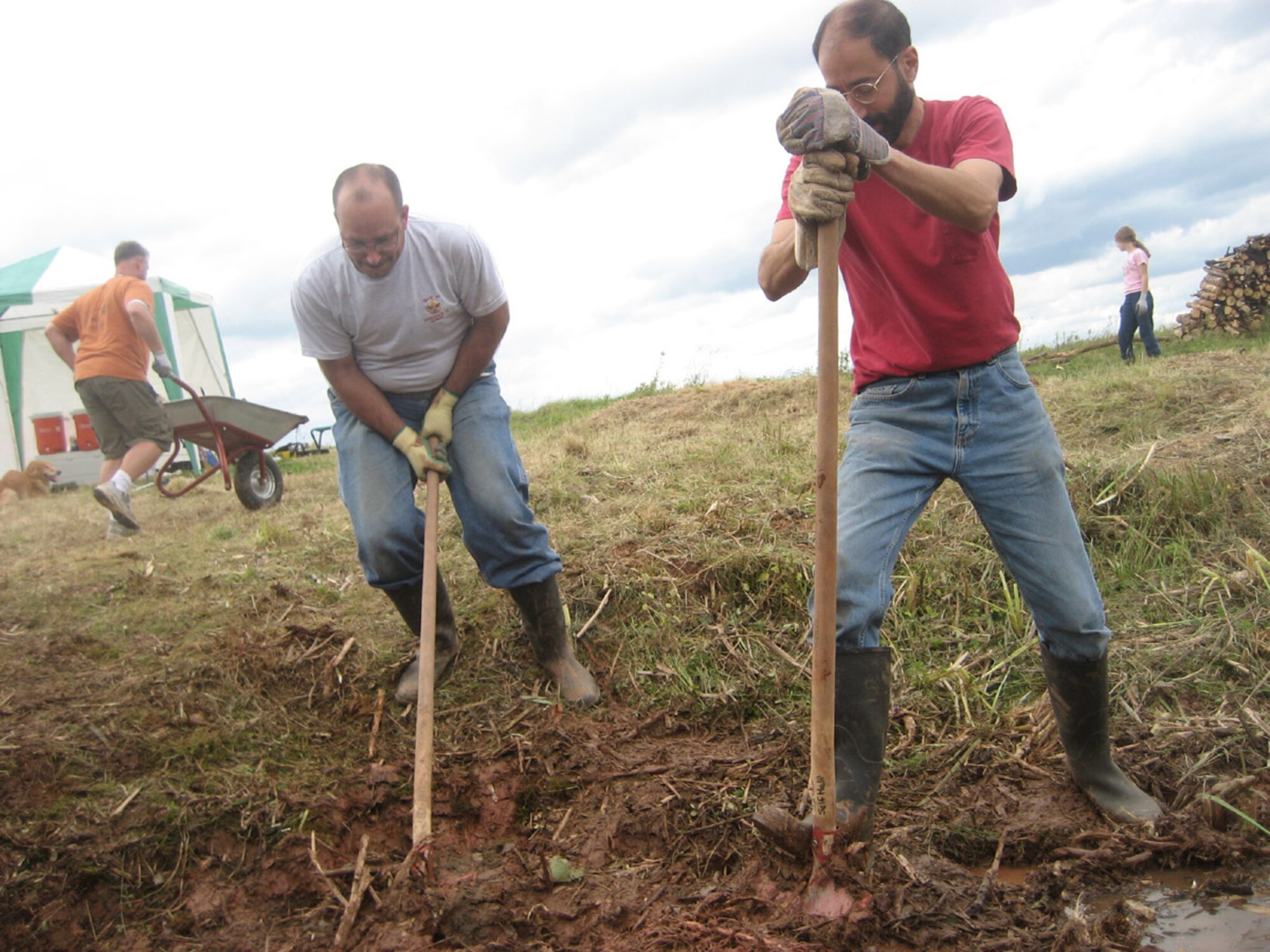 SPANGDAHLEM AIR BASE, Germany – From left: Senior Master Sgt. Daniel Demers, 52nd Component Maintenance Squadron, removes dirt, grass, trees and branches from an area where the Spangdahlem Boy Scouts recently reclaimed a wetland for frogs, toads, salamanders and other wildlife. Master Sgt. Kyle Thomas, 52nd Maintenance Group, and Chuck Ciranni, DRS Technology, dig up the ground Aug. 19 to make way for a pond to house the wildlife. (U.S. Air Force photo/Staff Sgt. Andrea Knudson)    