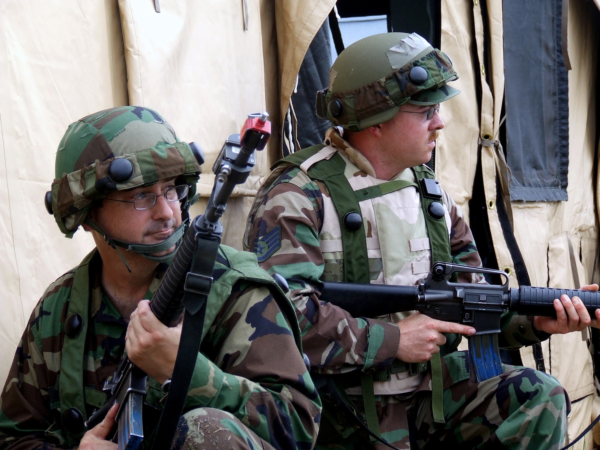 Air Force Civilian Alan Marsh, historian from Robins Air Force Base, Ga., and Staff Sgt. Joshua Richards, Keesler AFB, Miss., respond to a scenario in the fictional 421st Air Expeditionary Group camp for Air Force Exercise Eagle Flag 07-6 at Naval Air Engineering Station Lakehurst, N.J., Aug. 26.  The exercise is operated by the U.S. Air Force Expeditionary Center's 421st Combat Training Squadron at Fort Dix, N.J., and tests Airmen in expeditionary combat support career fields.  (U.S. Air Force Photo/Tech. Sgt. Scott T. Sturkol)