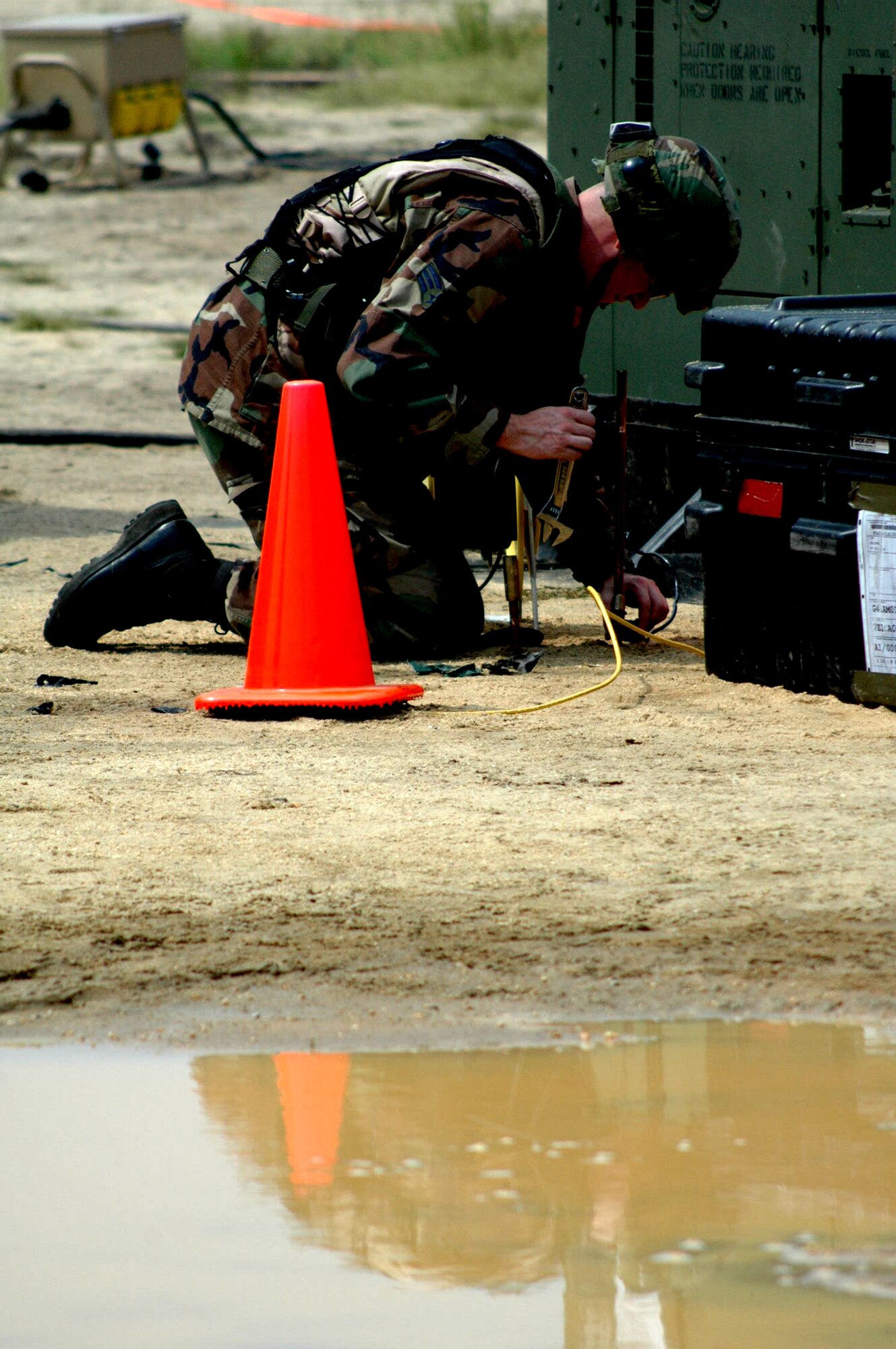 An Airman from the 816th Contingency Response Group, McGuire Air Force Base, N.J., works on grounding a generator at the CRG camp during operations for Air Force Exercise Eagle Flag 07-6 at Naval Air Engineering Station Lakehurst, N.J., Aug. 25.  The exercise is operated by the U.S. Air Force Expeditionary Center's 421st Combat Training Squadron at Fort Dix, N.J.  (U.S. Air Force Photo/Tech. Sgt. Scott T. Sturkol)