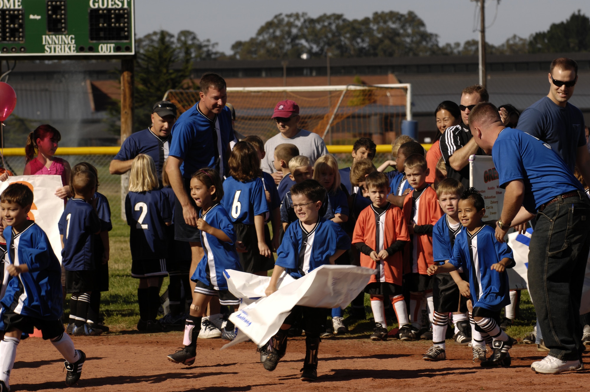 VANDENBERG AIR FORCE BASE, Calif. -- Children participating in the youth soccer program show their team spirit by running around the field during the youth soccer opening ceremony at the youth soccer field on Aug. 24. The youth soccer opening ceremony kicked off the two-month season for children ages 5 to 14 with games on Wednesday afternoons and Saturday mornings. (U.S. Air Force photo/Airman 1st Class Christian Thomas)