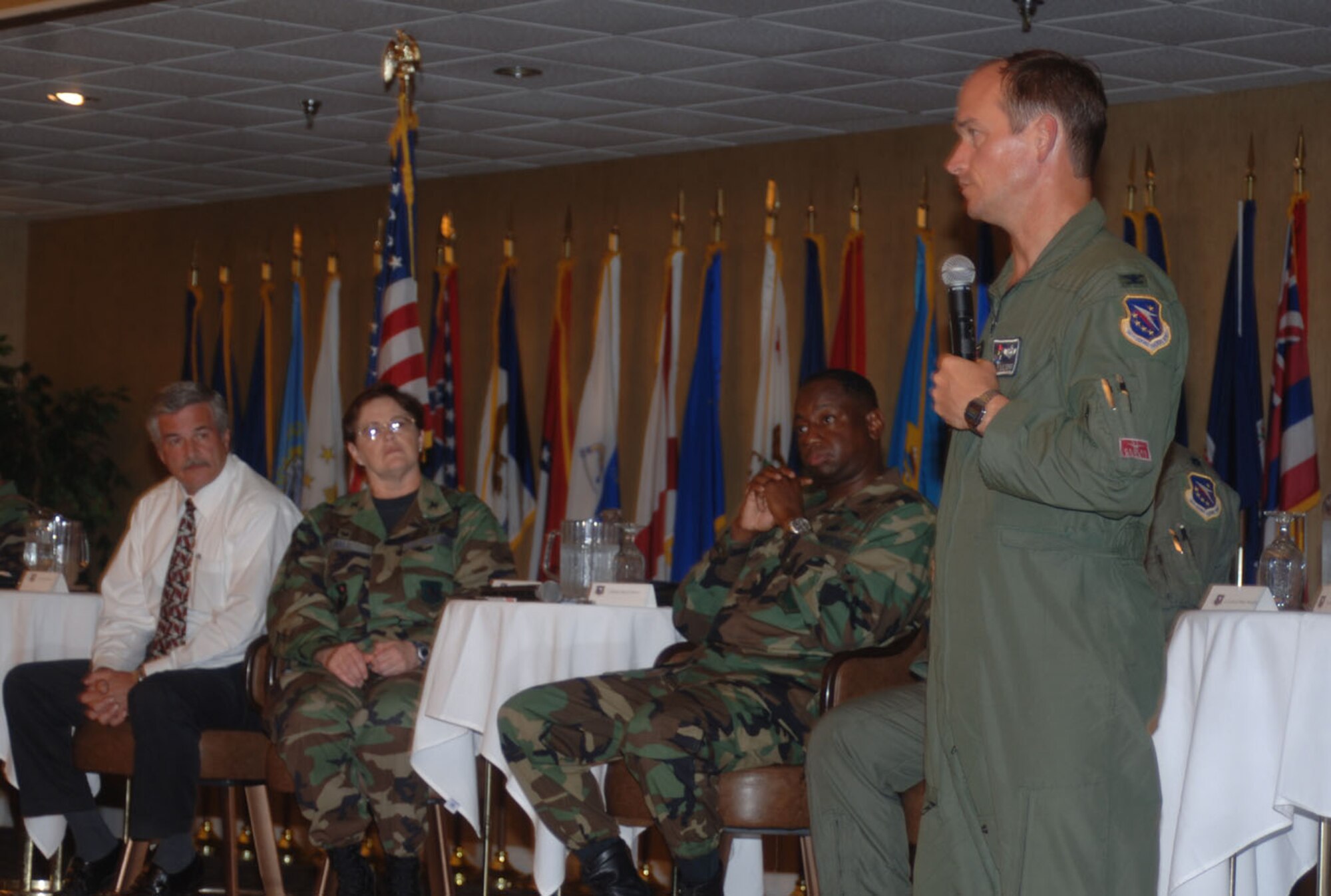 Colonel Dave Gerber, 14th Flying Training Wing commander, address the audience at the Town Hall Meeting Aug. 23 at the Columbus Club. Seen seated behind him are Gene Kinion, DynCorp division manager, Col. Susan Hall, 14th Medical Group commander, and Col. Mark Brown, 14th Mission Support Group commander. Issues such as school choice and housing privatization were discussed during the meeting. (U.S. Air Force photo by Airman 1st Class Danielle Powell)