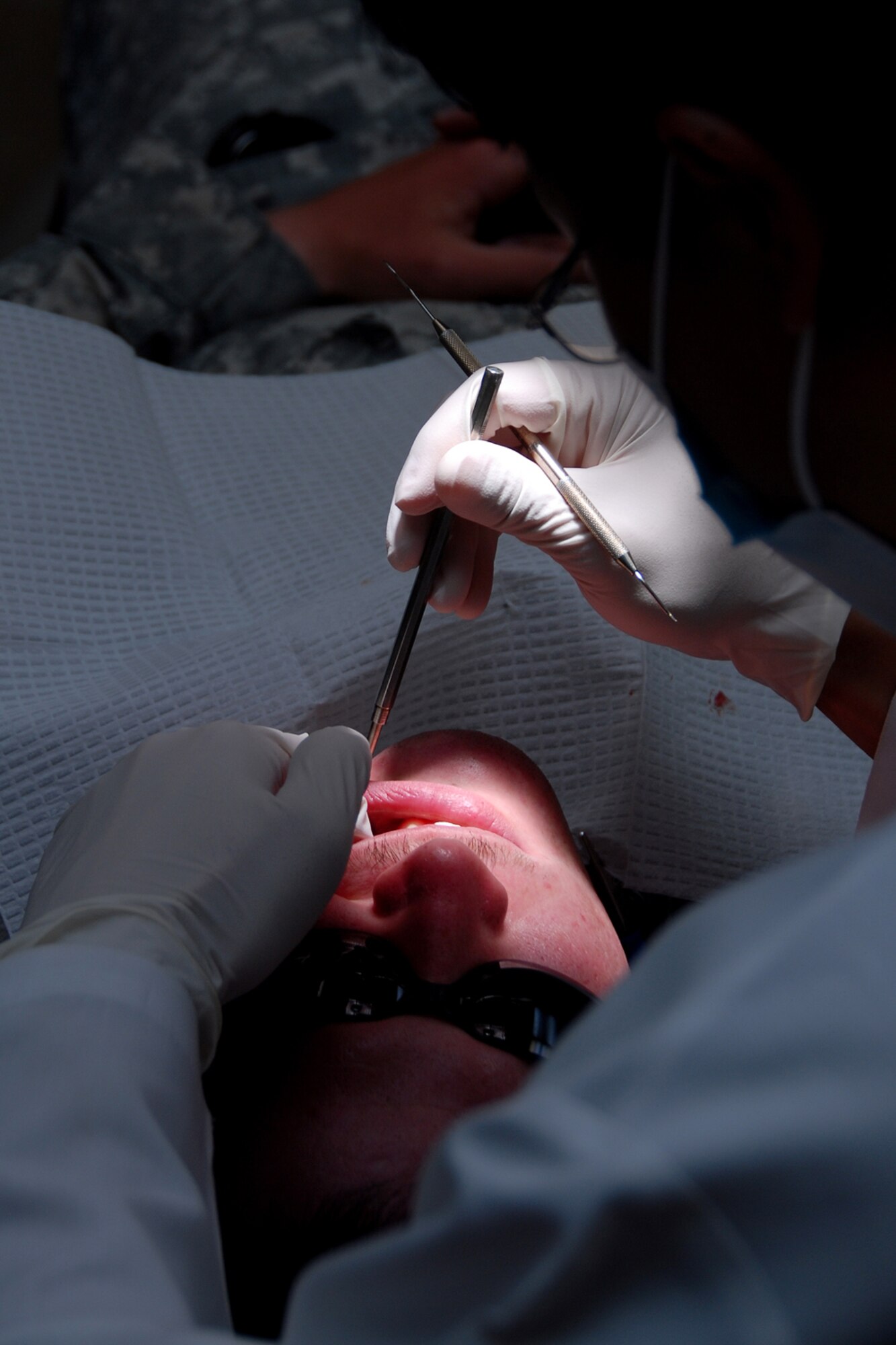 OSAN AIR BASE, Republic of Korea -- Captain Yaesok Yoo, a dentist with the 51st Dental Squadron dentist performs routine maintenance on Aug. 24. Osan's dental squadron performs numerous tasks to keep the Mustang Stampede smiling. (U.S. Air Force photo by Airman 1st Class Chad Strohmeyer) (Released)