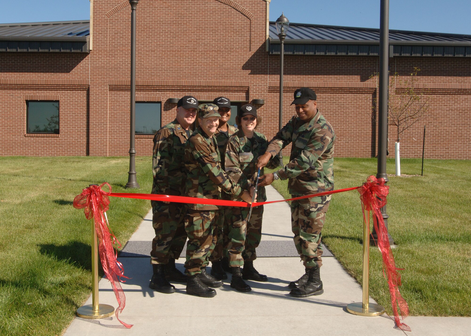 Col. John Taglieri, Air Mobility Command Deputy A6, Col. Diane Hull, 319th Air Refueling Wing commander, Lt. Col. Kurt Searfoss,  319th Mission Support Group deputy commander, Lt. Col. Daniel Liggins, 319th Communications Squadron commander, and Chief Master Sgt.  Cynthia Massie, 319th Mission Support Group superintendent, do the honors of cutting the ribbon for the Grand Opening of the Network Control Center here Aug. 29. (U.S. Air Force photo/Airman 1st Class Chad Kellum)