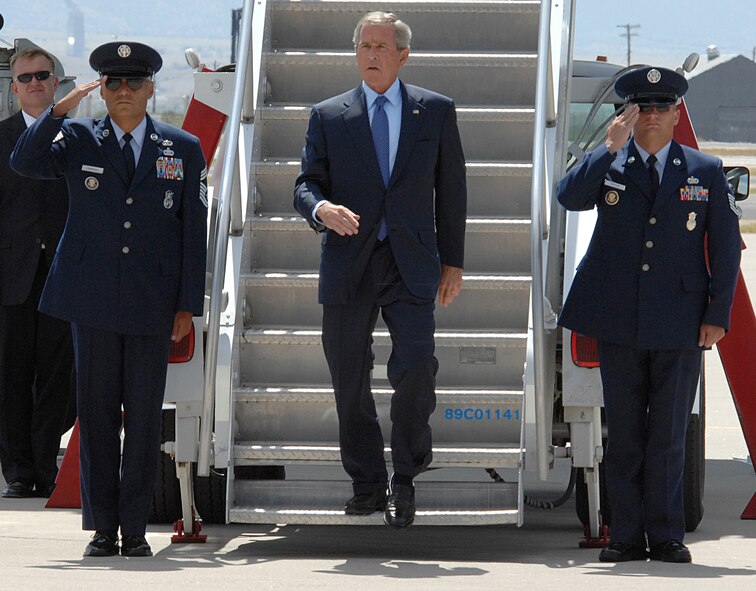 President Bush is saluted by Air Force One's security team upon his arrival at Kirtland Air Force Base, New Mexico.  The president was here for a luncheon in Albuquerque Aug. 27.  U.S. Air Force photo by Helga Carter
