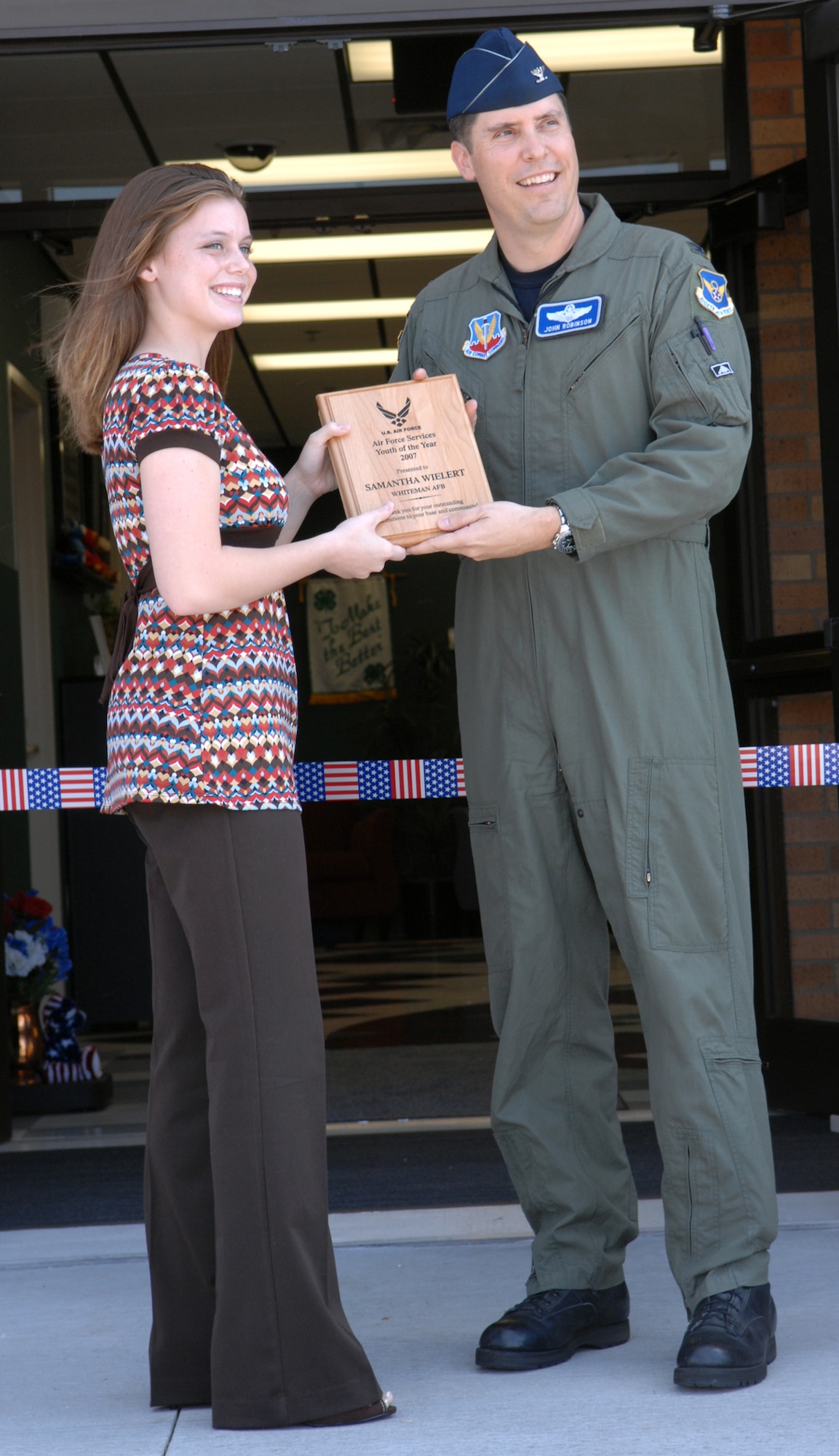 WHITEMAN AIR FORCE BASE, Mo. – Col. John Robinson, 509th Bomb Wing vice commander gives the 2007 Air Force Services Youth of the Year Award to Samantha Wielert at the youth center ribbon cutting ceremony Aug. 24. The youth center programs include before and after school care, youth sports and fitness and youth development and recreation programs for youth ages 5-18 years of age. (U.S. Air Force photo/Airman 1st Class Stephen Linch)


