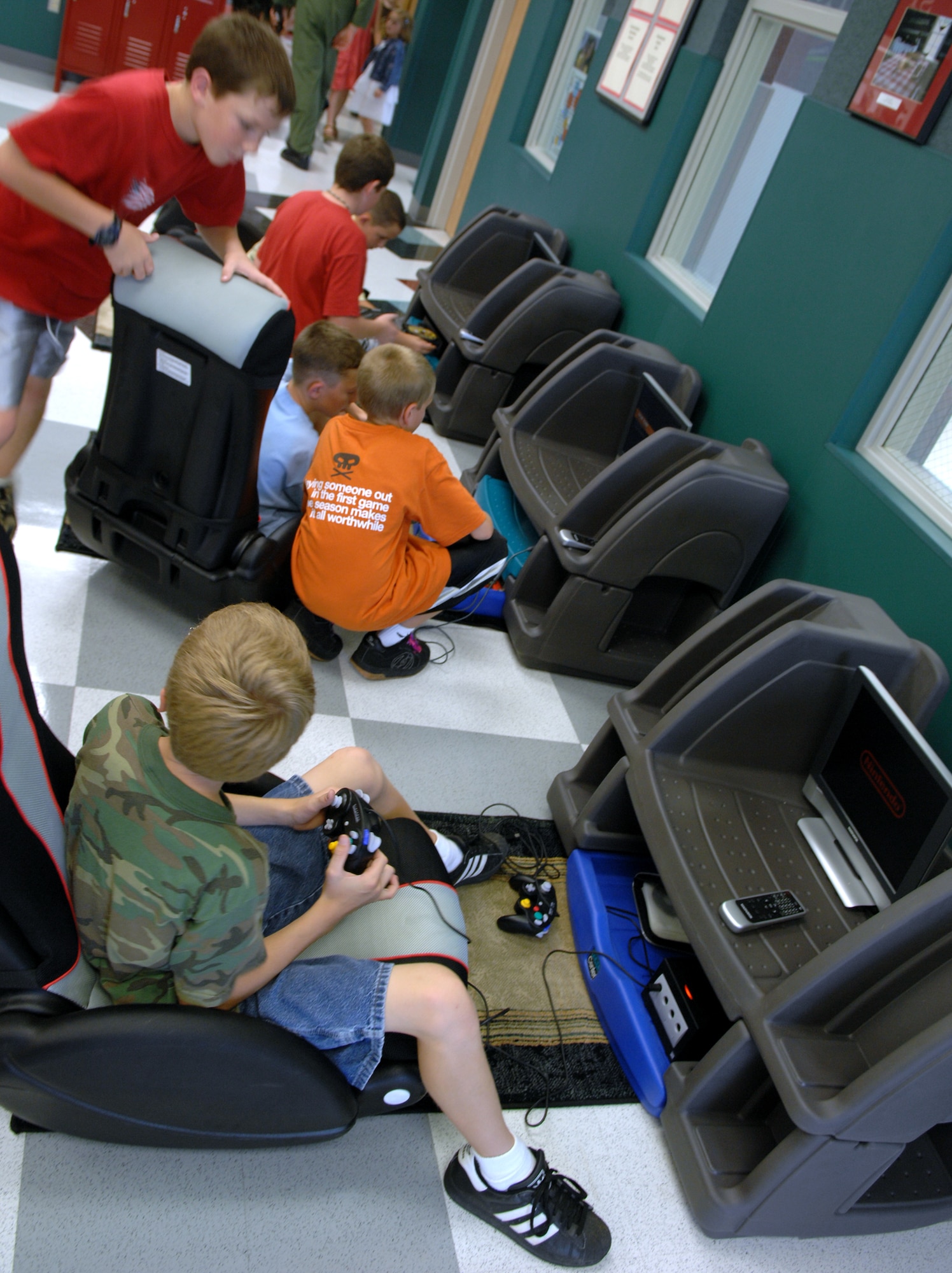 WHITEMAN AIR FORCE BASE, Mo. – Whiteman youth play videogames on several different gaming consoles that the new youth center offers after the ribbon cutting ceremony Aug. 24. The youth center’s mission is to provide a safe, high-quality youth development program in an environment that is both nurturing and stimulating. (U.S. Air Force photo/Airman 1st Class Stephen Linch)
