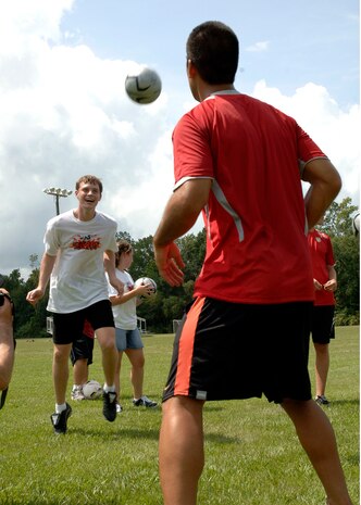 Ben Jones, a Dorchester Dragons Special Olympics soccer player, learns how to use his head with the help of Charleston Battery Soccer player Chris Goner during the Special Olympics Soccer kickoff event at the Summerfield Soccer Club on Saturday. Members from Charleston AFB are volunteering their time to help coach the team. (U.S. Air Force Photo/Airman 1st Class Cynthia Spalding)