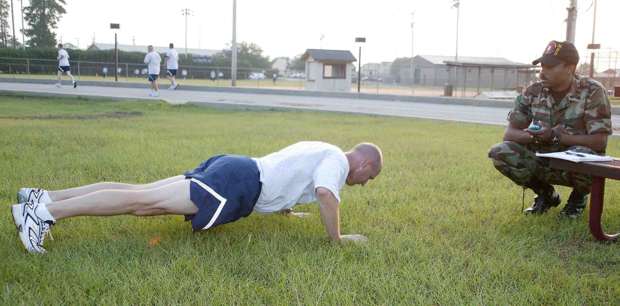 SHAW AIR FORCE BASE, S.C. -- Col. James Post, 20th Fighter Wing commander, performs push ups during his annual fitness evaluation Aug. 28 while 2nd Lt. Johnathan Colley, 20th Mission Support Squadron physical training leader, keeps time. The fitness test is now part of the enlisted and officer performance report. Colonel Post earned a perfect score on his fitness evaluation.  (U.S. Air Force photo/Senior Airman John Gordinier)