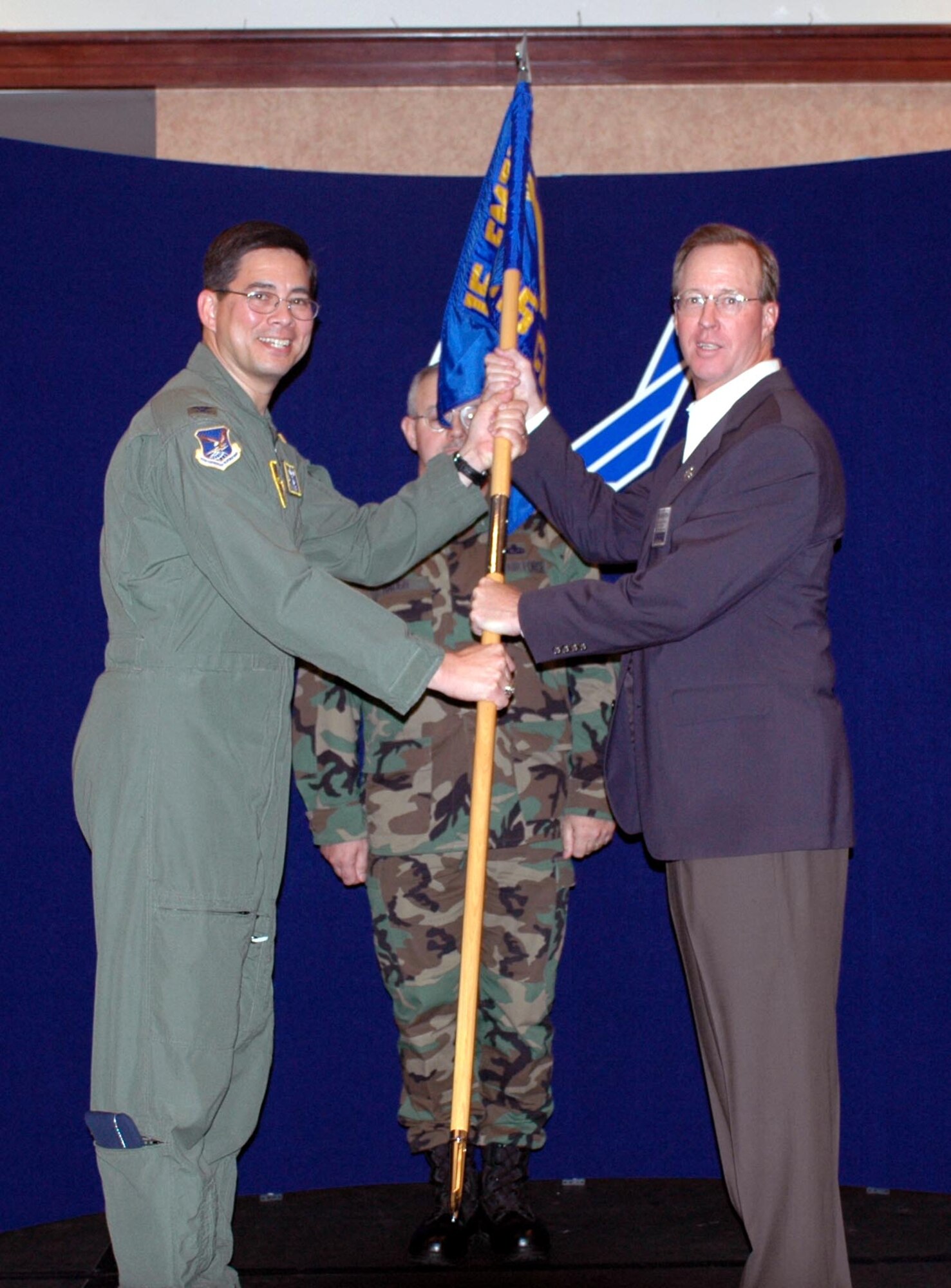 Foy McNaughton, Fairfield Daily Republic, accepts honorary command of the 615th Contingency Response Wing from Col. Anthony Hinen, 615th CRW commander during the honorary commanders' assumption-of-command ceremony Aug. 24. (U.S. Air Force photo/Airman 1st Class Kristen Rohrer)
