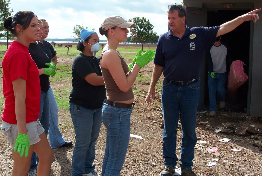 Ernie Mills (right), manager of the Sheppard Annex at Lake Texoma, briefs volunteers on their next assignment during the first clean-up gathering following extensive flooding at the East Texas lake. About 40 volunteers helped the staff of the annex get the site ready to begin accepting guests. (U.S. Air Force photo/courtesy of 82nd Mission Support Squadron)