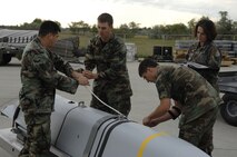 MINOT AIR FORCE BASE, N.D. -- Airmen from the 5th Munitions Squadron inspect a joint air-to-surface standoff missile here Aug. 17. The 5th Bomb Wing will test fly two missions a week for 12 weeks with an AGM-158 JASSM. (U.S. Air Force photo by Senior Airmen Christopher Boitz) 