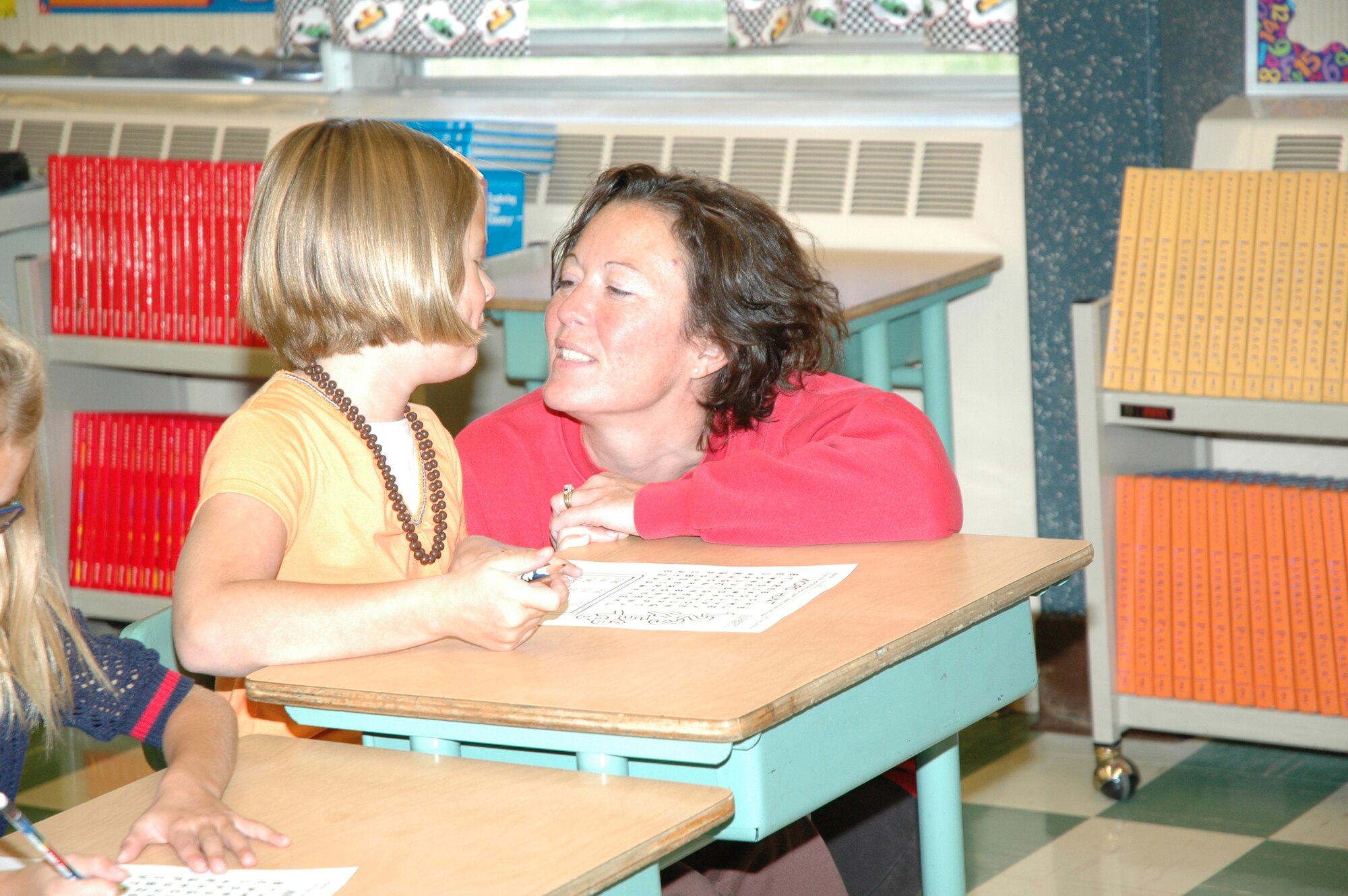 Little Warrior Harlee, 8, and her mom, Dovie, share a special moment on the first day of school Wednesday. Harlee is a second grader at Loy Elementary School (U.S. Air Force photo/Valerie Mullett)