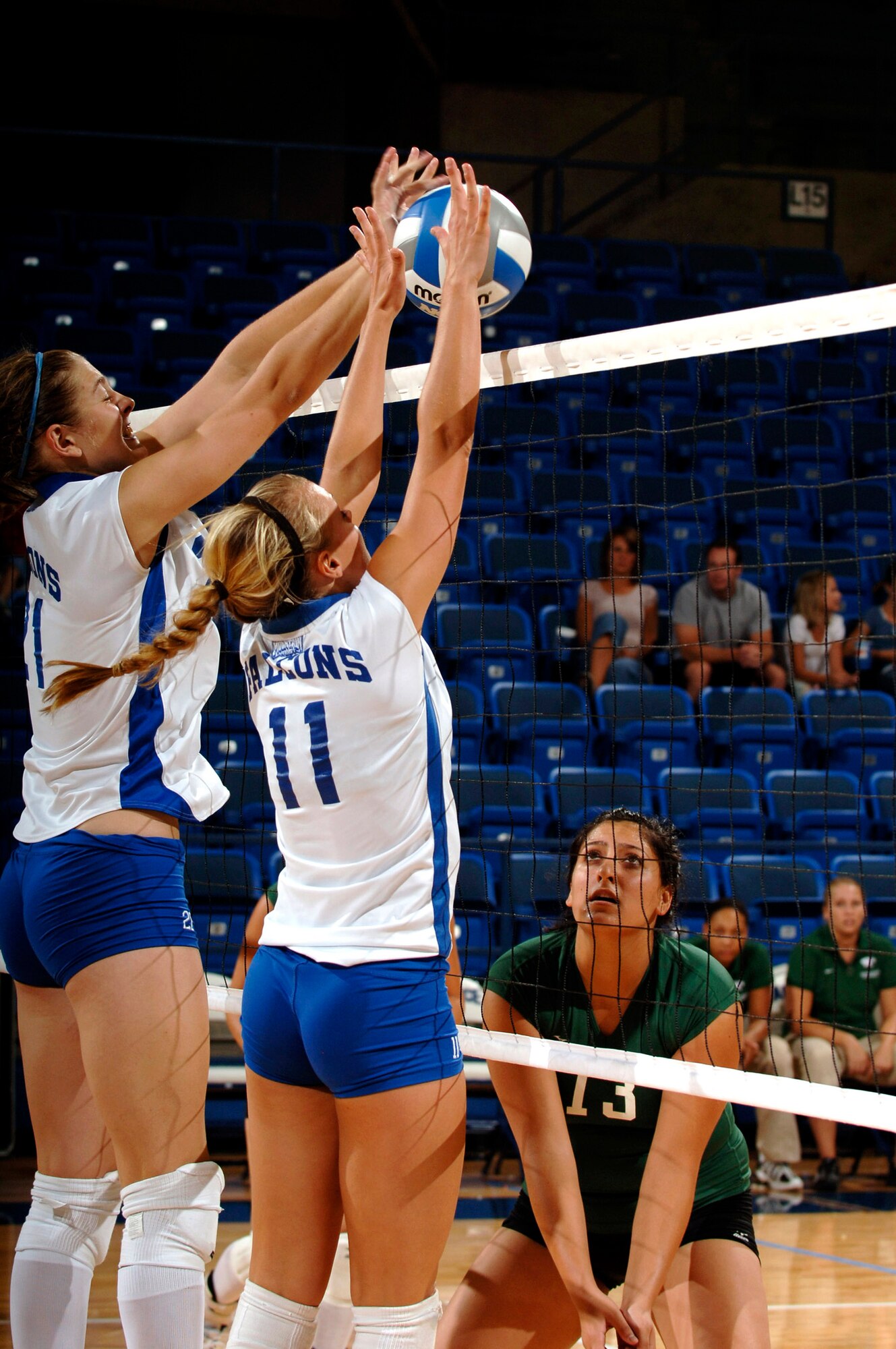 U.S. Air Force Academy sophomore Michelle Harrington (left) and senior Kim Kallibis block a Chicago State spike Aug. 24 as Jessica Khouri braces for the ball at Clune Arena at the Academy in Colorado. The Falcons swept the Cougars, 3-0, en route to a second place finish in the Air Force Invitational Tournament. (U.S. Air Force photo/Mike Kaplan) 

