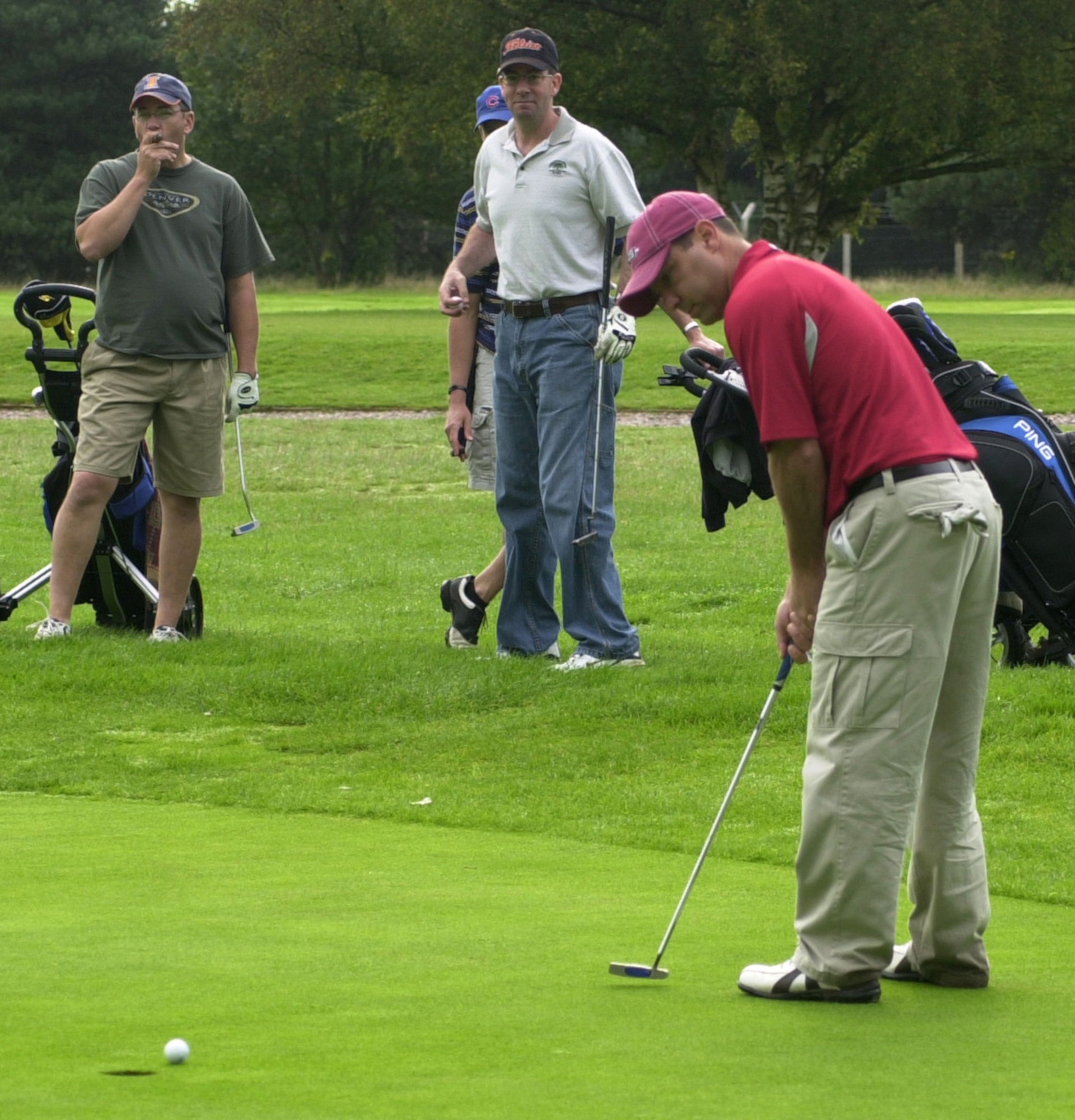 Tony Amoroso, 100th Mission Support Squadron, lips out on the seventh green in the semi-finals of intramural golf at Breckland Pines Golf Club, Aug. 28, Rich Coyle and Morris Smith looking on. (Air Force photo by Gary Rogers)