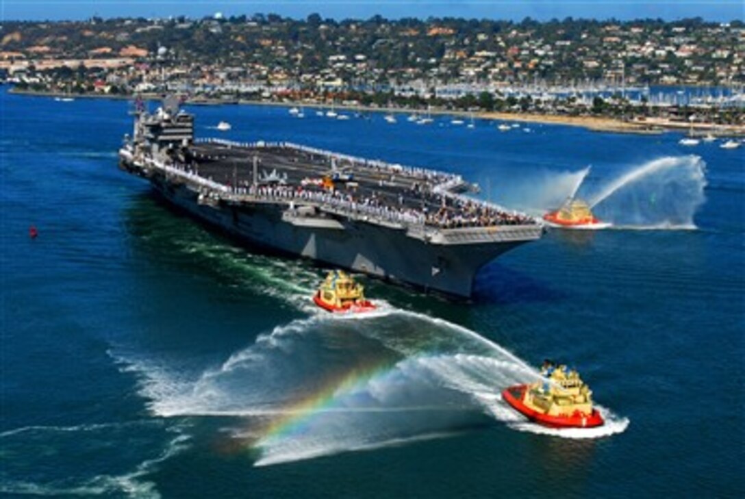 Tugboats shoot plumes of water into the air as the aircraft carrier USS John C. Stennis (CVN 74) pulls into San Diego, Calif., on Aug. 27, 2007.  The Nimitz-class carrier stopped in San Diego to offload personnel and equipment of Carrier Air Wing 9 before returning to its homeport of Bremerton, Wash.  