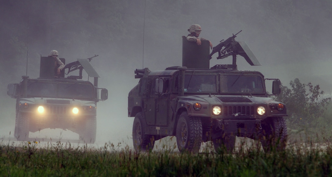 Marines with Combat Logistics Battalion 24 (CLB 24), attached to the 24th Marine Expeditionary Unit (24th MEU), perform a series of live fire runs on a convoy range at Fort Pickett, VA firing M249 and M240 machine guns at targets along the road side. Training like this will prepare the Marines for possible convoy missions in a combat environment. (US Marine Corps photo by Corporal Andrew J. Carlson)