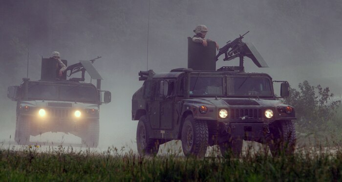 Marines with Combat Logistics Battalion 24 (CLB 24), attached to the 24th Marine Expeditionary Unit (24th MEU), perform a series of live fire runs on a convoy range at Fort Pickett, VA firing M249 and M240 machine guns at targets along the road side. Training like this will prepare the Marines for possible convoy missions in a combat environment. (US Marine Corps photo by Corporal Andrew J. Carlson)