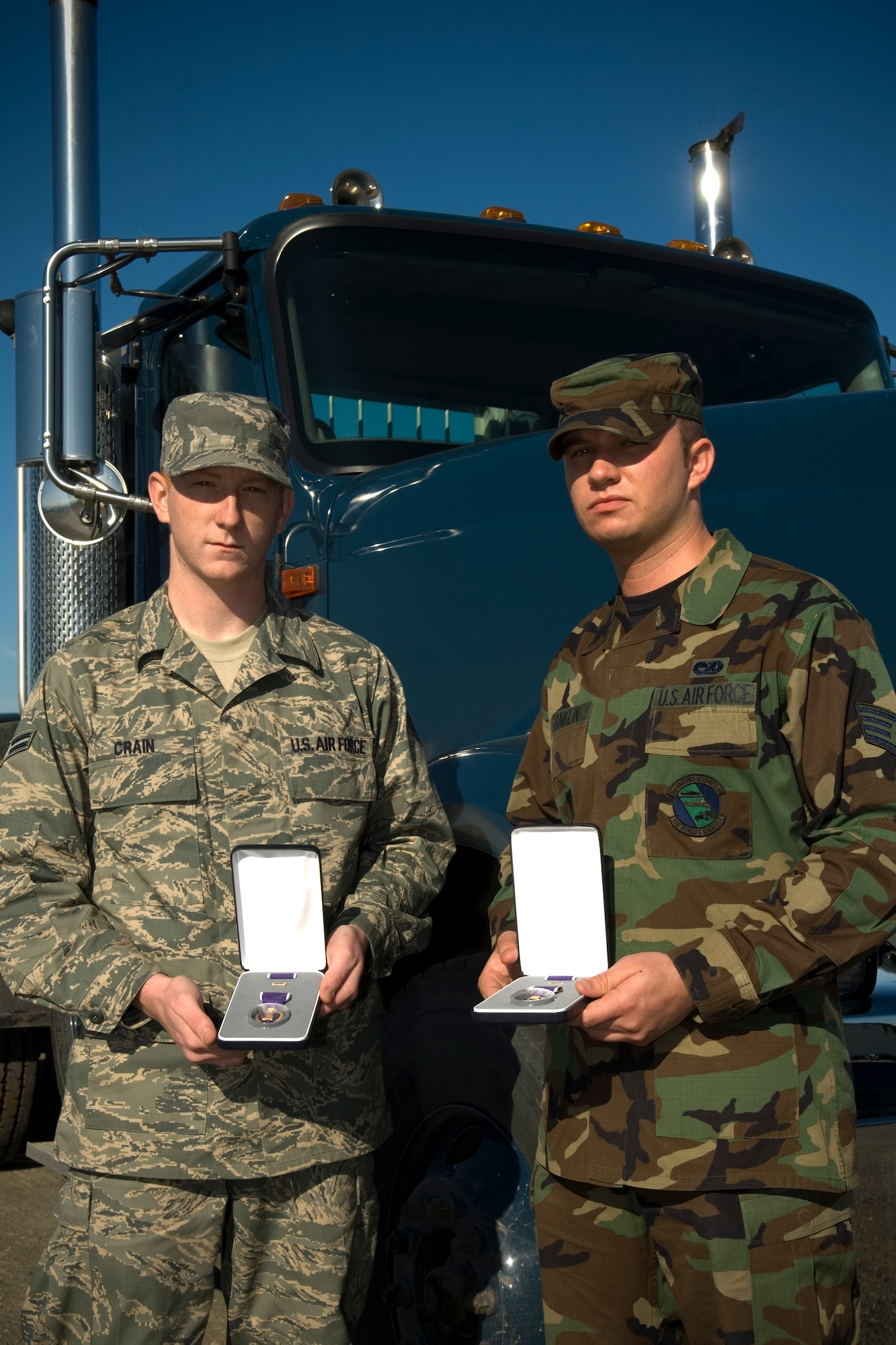 Airman 1st Class Benjamin Crain (left) and Staff Sgt. Larry Franklin (right), both from the 3rd Logistics Readiness Squadron, received the Purple Heart in a ceremony Aug. 28. (U.S. Air Force photo by Senior Airman Garrett Hothan) 