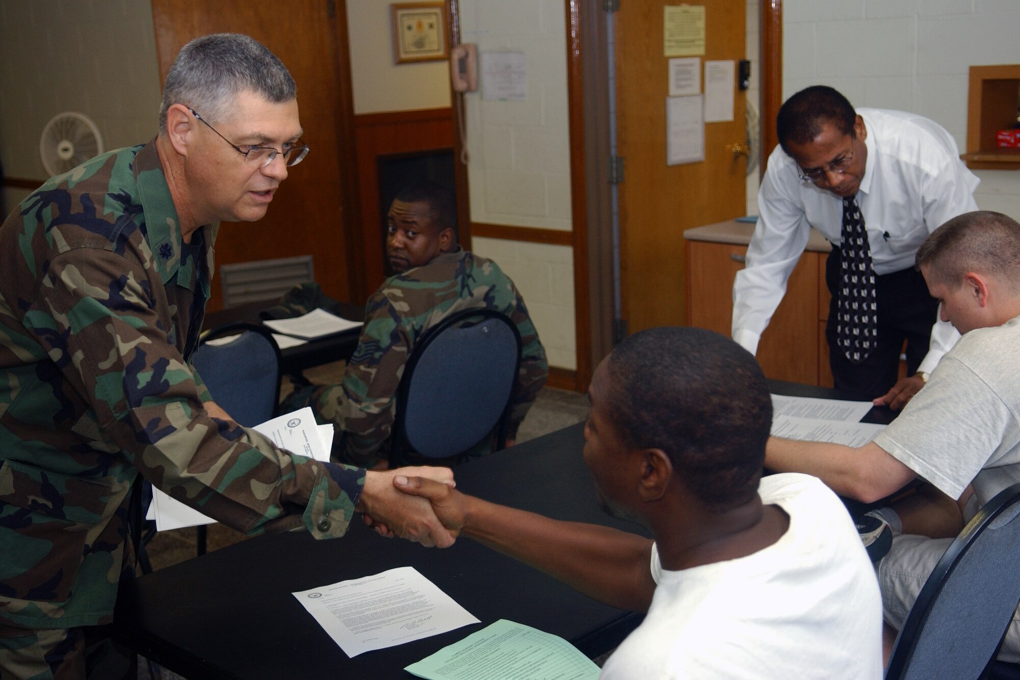 OSAN AIR BASE, Republic of Korea -- Chaplain (Lt. Col.) Charles Cornelisse and Mr. Clarence Figgs, a financial advisor from the Airman and Family Readiness Center, brief members of Team Osan about marriage to non-U.S. citizens.  The monthly class is sponsored by the Integrated Delivery System, a group of various base support agencies. For more information, call the Chapel at 784-5000. (Air Force photo by Staff Sgt. Christopher A. Marasky)