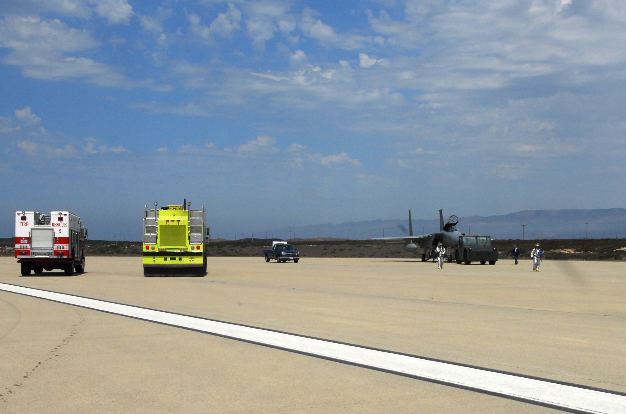 VANDENBERG AIR FORCE BASE, Calif. -- Airfield operators and Firefighters in flightline fire suits respond to an F-15A Eagle that landed on Vandenberg's flight line Aug. 30 due to operational difficulties. (U.S. Air Force photo/Airman 1st Class Robert Lewis)