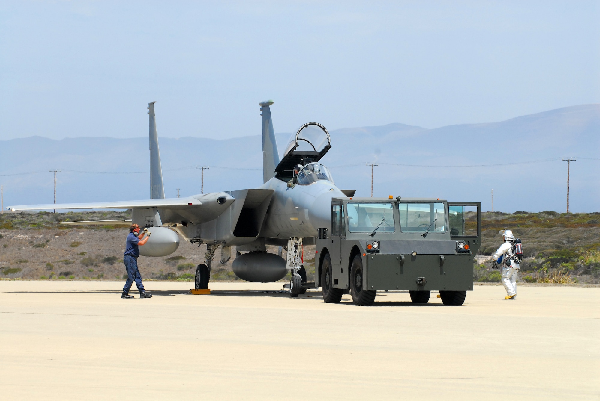 VANDENBERG AIR FORCE BASE, Calif. -- Airfield operators and Firefighters in flightline fire suits respond to an F-15A Eagle that landed on Vandenberg's flight line Aug. 30 due to operational difficulties. (U.S. Air Force photo/Airman 1st Class Robert Lewis)