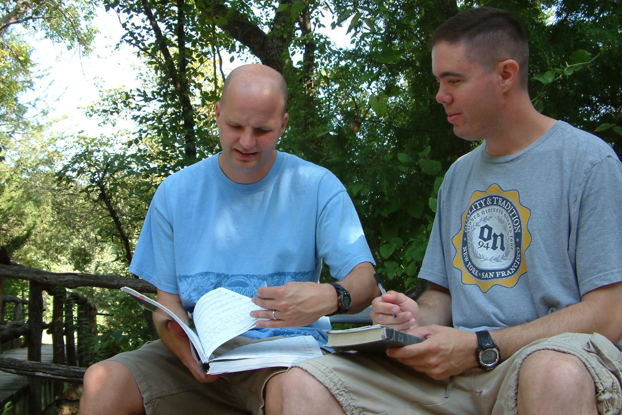 MCCONNELL AIR FORCE BASE, Kan. – Chaplains (Capts.) Travis Sears and Kevin Hudson review the songs for worship service during the 22nd Maintenance Group reunion and reintegration retreat at the Rock Springs 4-H Center, near Junction City, Kan., Aug. 26. More than 70 military members, some recently returned from deployment, and their families participated in the event. (U.S. Air Force photo by Tech. Sgt. Chyrece Campbell)