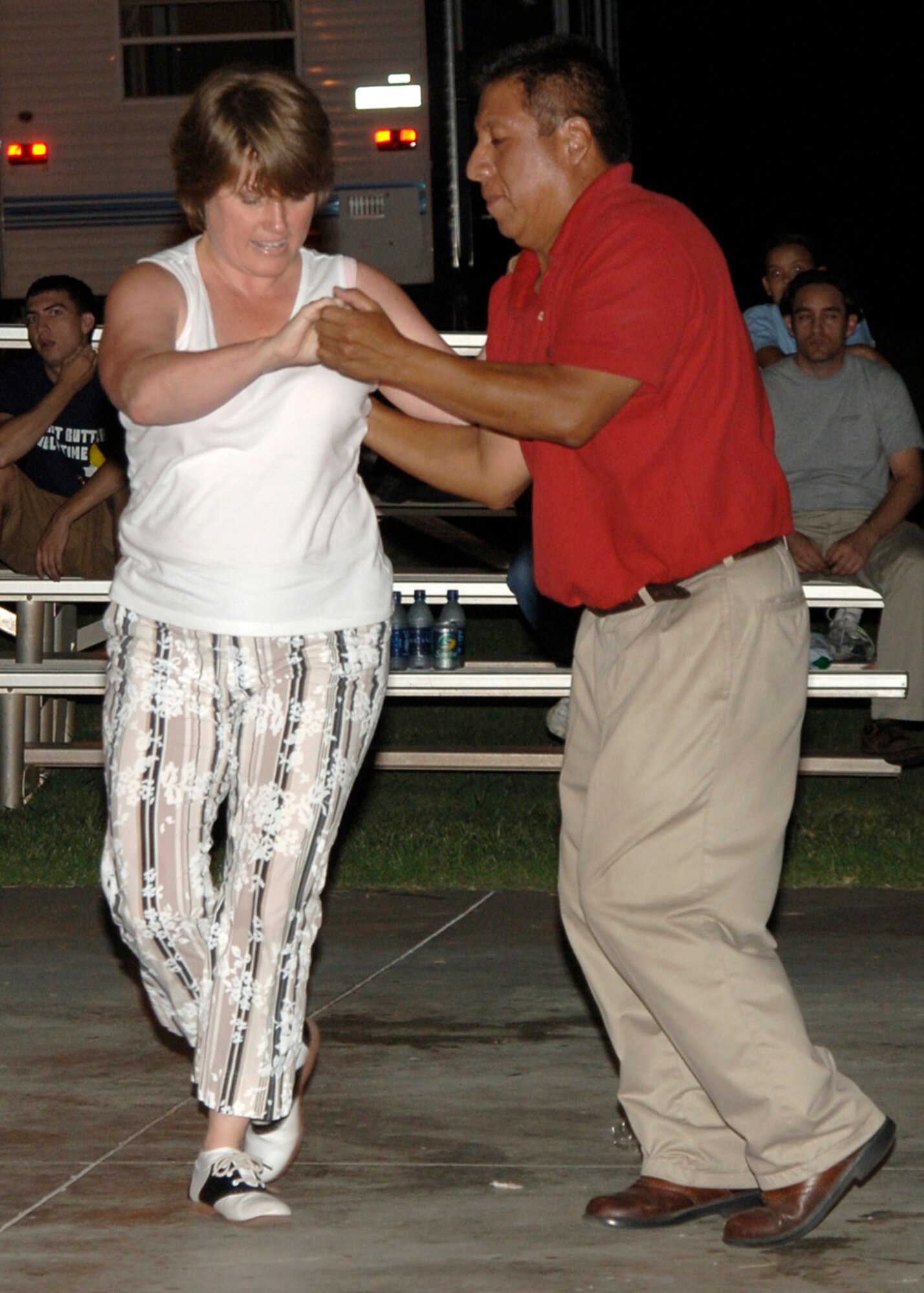 MCCONNELL AIR FORCE BASE, Kan. –Ulysses Martinez, right, and Micki Johnston, block party venders, participate in a dance-off during the base MatchUp block party Aug. 25. Mr. Martinez and Mrs. Johnston won best performers for their participation in the swing dancing portion of the competition. Until Aug. 31, Air Mobility Command personnel and their family members can participate in MatchUp, AMC's summertime program through which participants can win big prizes for participating in various activities at their bases. This year's program will award more than 9,600 prizes in 90 days. Players receive game pieces for participating in MatchUp designated events. For more information, visit the MatchUp Web site at http://www.amcmatchup.com/rules.aspx. (Photo by Airman 1st Class Laura Suttles)