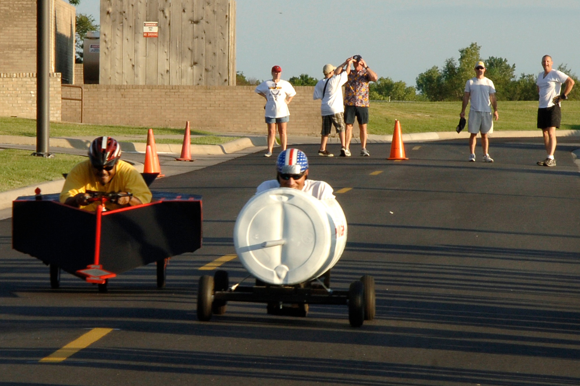 MCCONNELL AIR FORCE BASE, Kan. – Senior Master Sgt. Rodney Hicks, left, a 22nd Logistics Readiness Squadron member representing base first sergeants, races against Capt. Roger Lee, a 22nd Aeromedical-Dental Squadron member representing the 22nd Medical Group, during a soap box derby at the annual McConnell MatchUp block party here Aug. 25. The two finished the race in a tie. Until Aug. 31, Air Mobility Command personnel and their family members can participate in MatchUp, AMC's summertime program through which participants can win big prizes for participating in various activities at their bases. This year's program will award more than 9,600 prizes in 90 days. Players receive game pieces for participating in MatchUp designated events. For more information, visit the MatchUp Web site at http://www.amcmatchup.com/rules.aspx. (Photo by Airman 1st Class Laura Suttles) 
