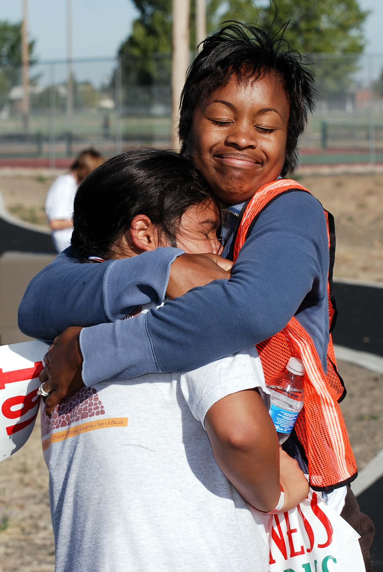 FAIRCHILD AIR FORCE BASE, Wash. – Celest Kuntz, Health and Wellness Center educator, gives Kristian Querido, 11, a congratulatory hug after Kristian’s successful completion of the first annual Kids Wellness Triathlon here Aug. 25. The HAWC sponsored the event to promote a healthy lifestyle, self-confidence and community spirit. Seventeen kids, ranging from toddlers through age 15, participated in the triathlon. (U.S. Air Force photo / Staff Sgt. Mikel Daniel)