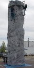Montana State University freshmen Kip Kirol and Bronson Stubbs climb the Montana Army National Guard climbing wall during the "Operation Care Package" fund-raiser at the Montana Veterans Memorial in Great Falls Aug. 27. The event provided Great Falls community members a chance to donate money to help purchase care packages to send to deployed servicemembers. (U.S. Air Force photo/Airman 1st Class Dillon White)