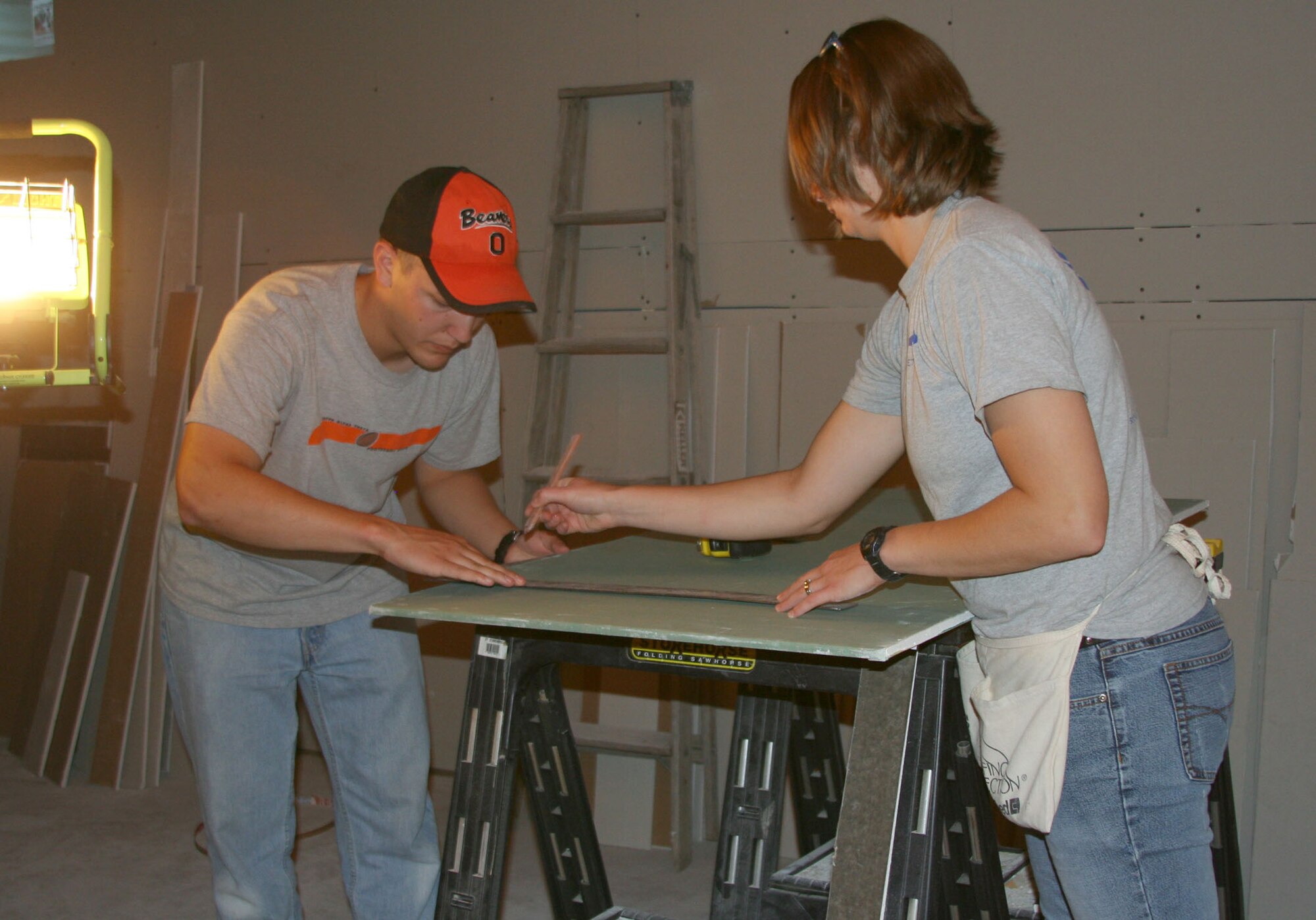 1st Lt. Kevin Hummert and 2nd Lt. Tamara Wyatt measure and cut drywall at a home constructed by volunteers with Habitat for Humanity in Great Falls, Mont. Lieutenant Hummert, with the 341st Operations Group, and Lieutenant Wyatt, from the 341st Comptroller Squadron, were two of the five company grade officers who volunteered to help a local family work on building their home Aug. 29. The home’s projected completion date is the end of October. (U.S. Air Force photo/Senior Airman Eydie Sakura